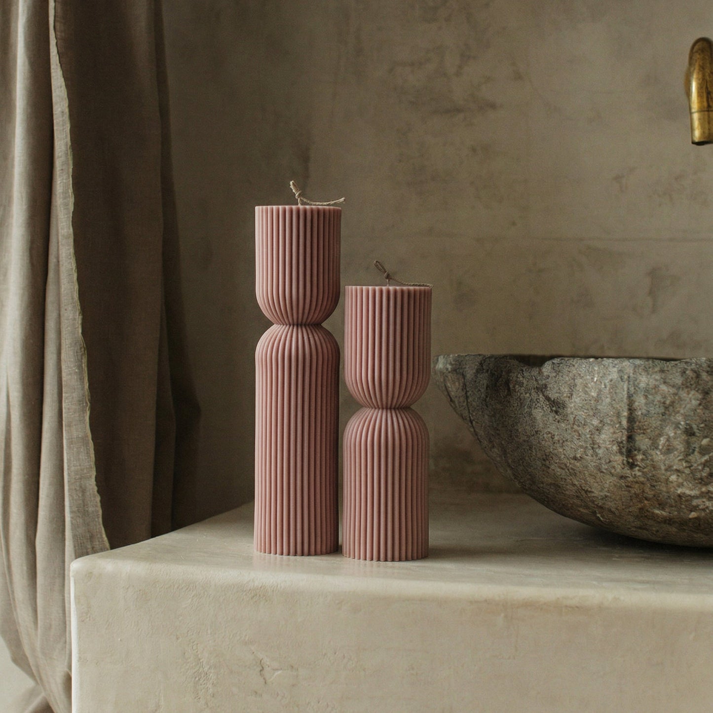 Close-up detail of handmade hourglass sculptural candle showing smooth soy wax texture and natural cotton wick