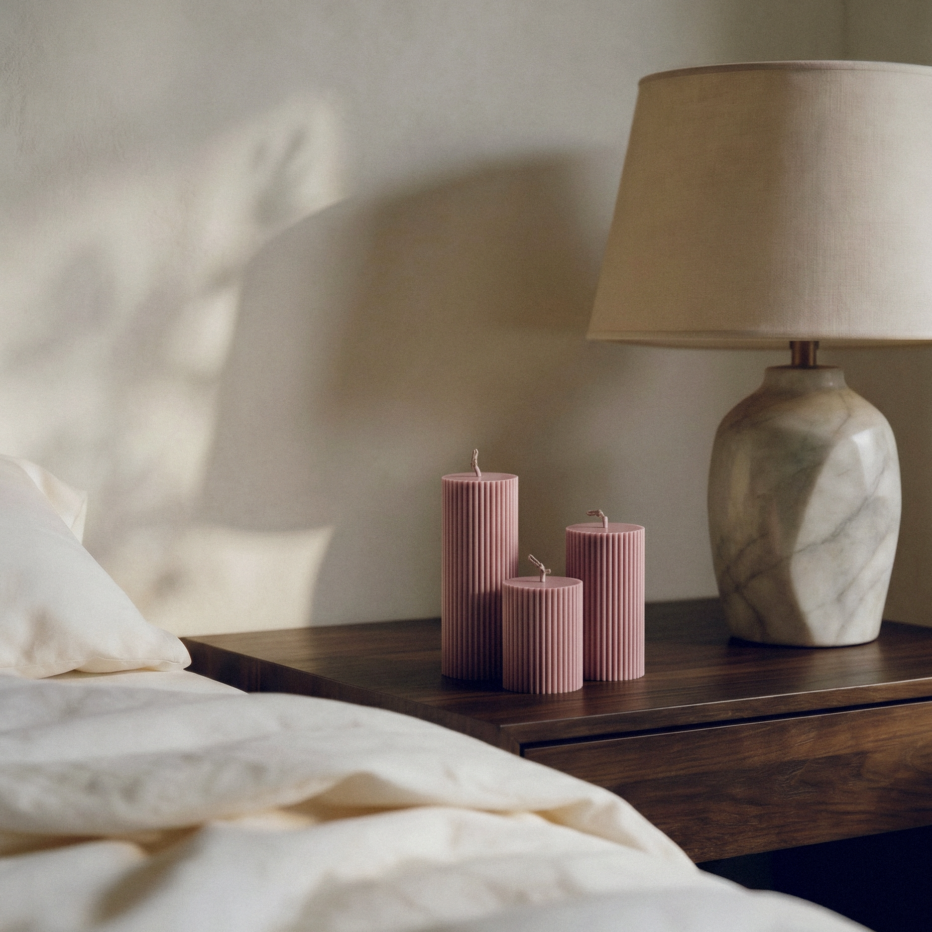 Close-up detail of handmade ribbed sculptural candle showing textured soy wax surface and natural cotton wick