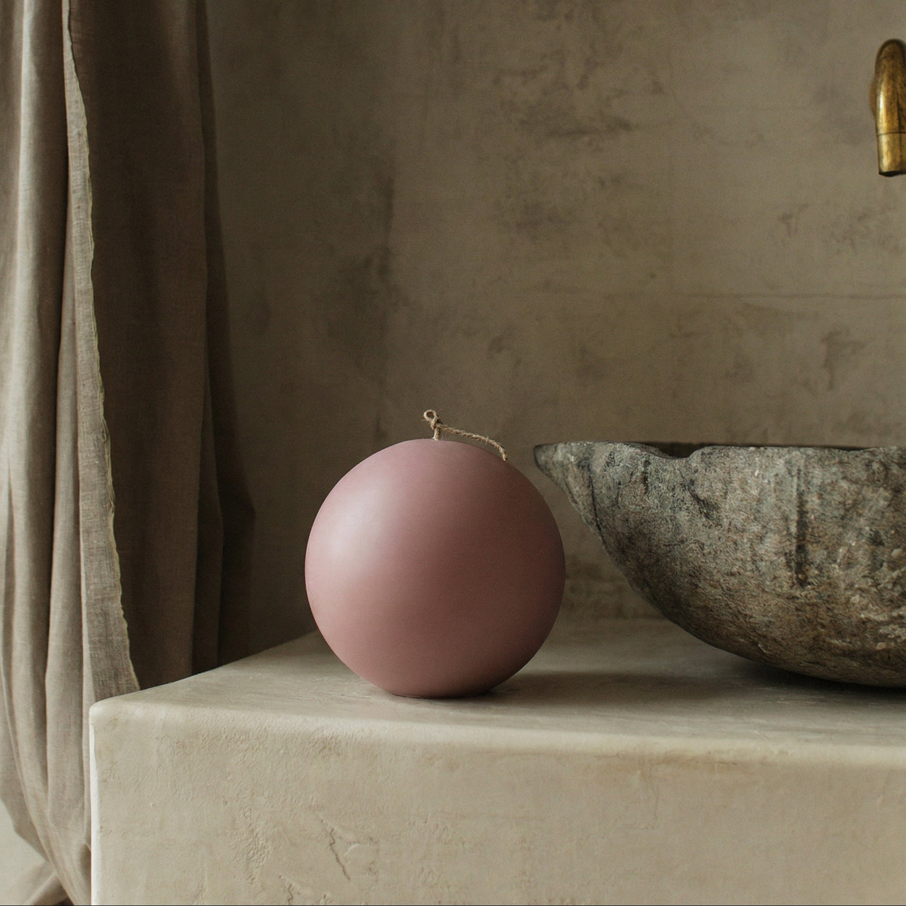 Handmade sculptural sphere candle detail showing smooth soy wax texture on minimalist surface in Los Angeles studio