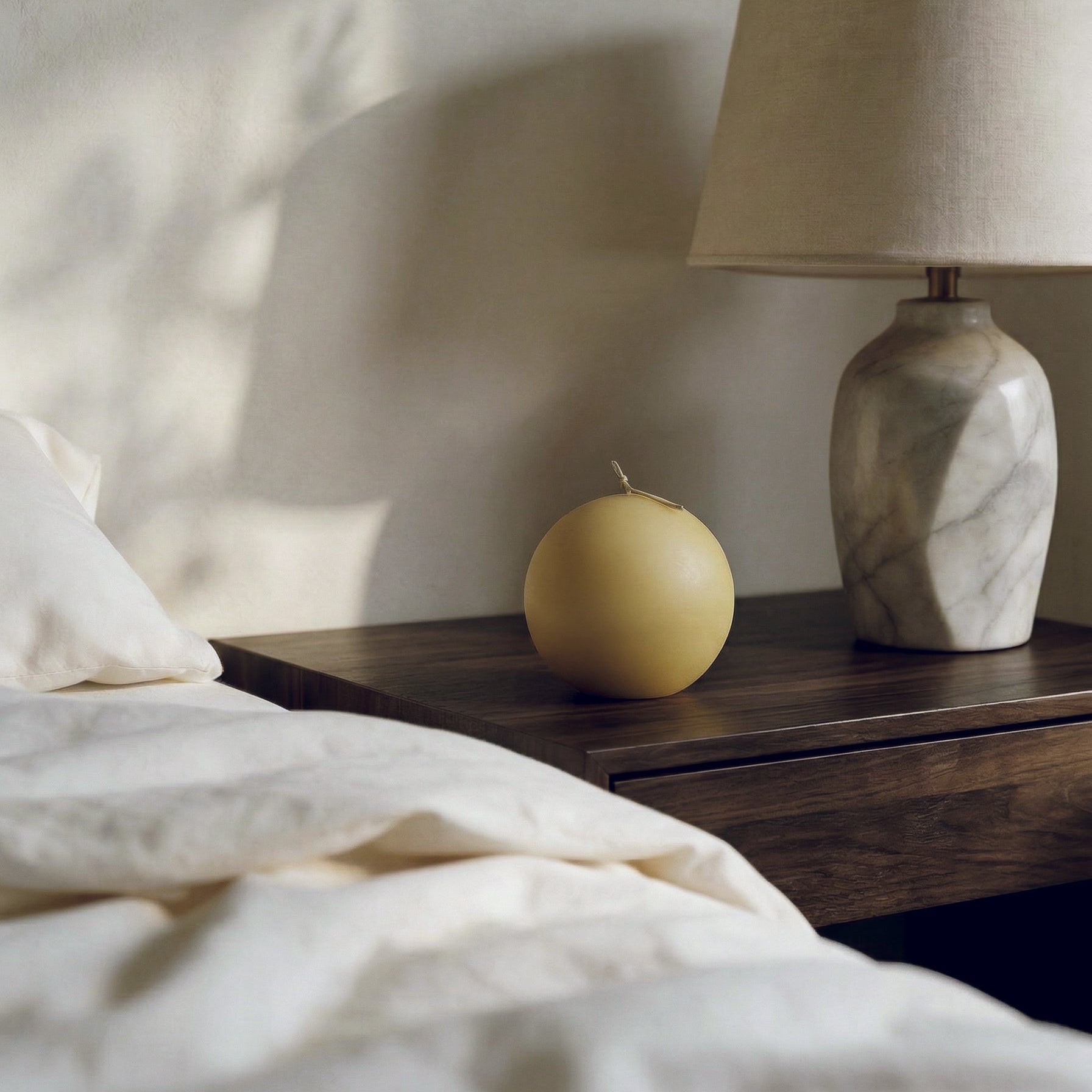 Handmade sphere sculptural candle detail showing smooth soy wax texture in natural light