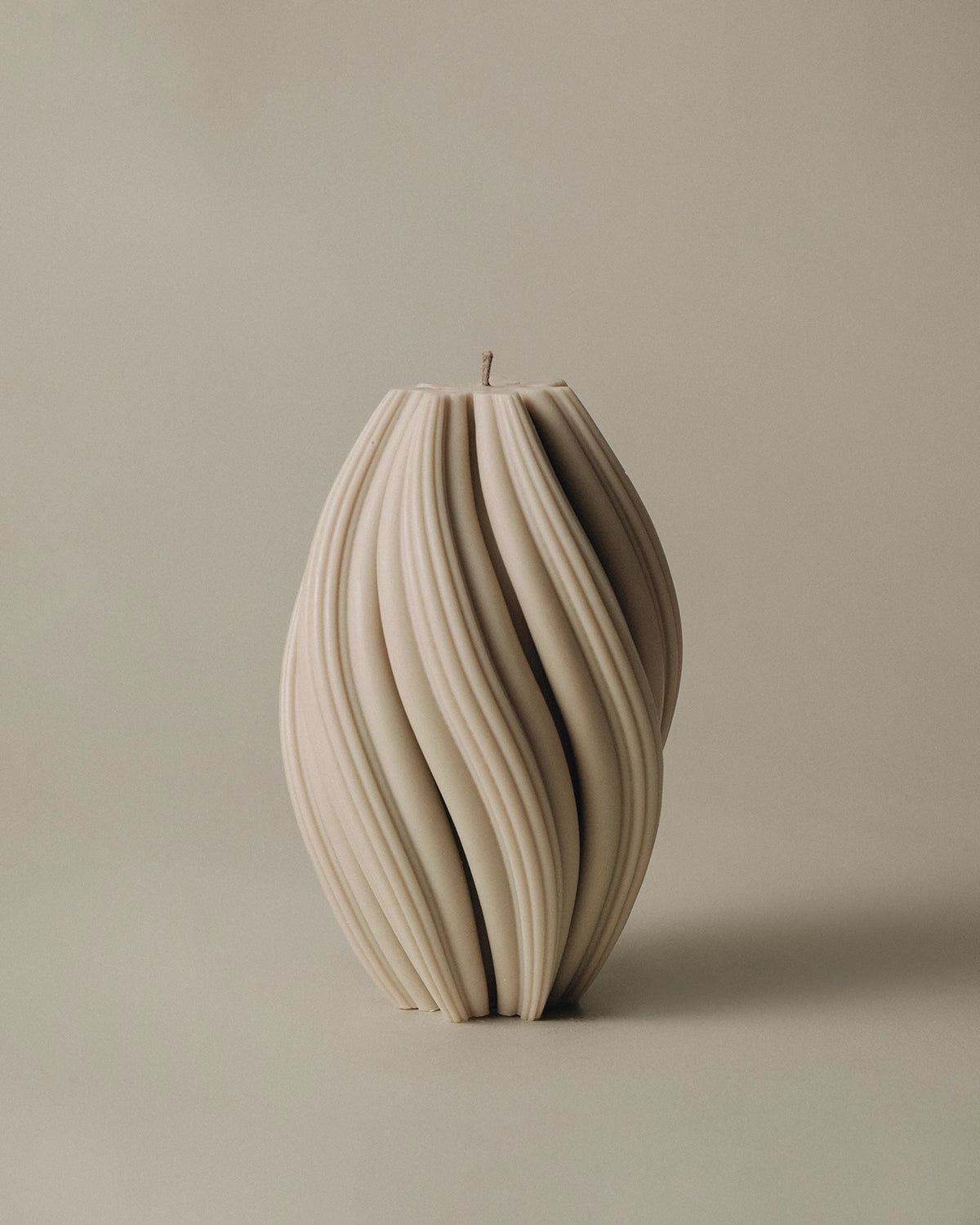 LAWA Candles Swirl Candle, large, in Sandstone soy wax with spiraling twisted ridges, product photo on a plain background