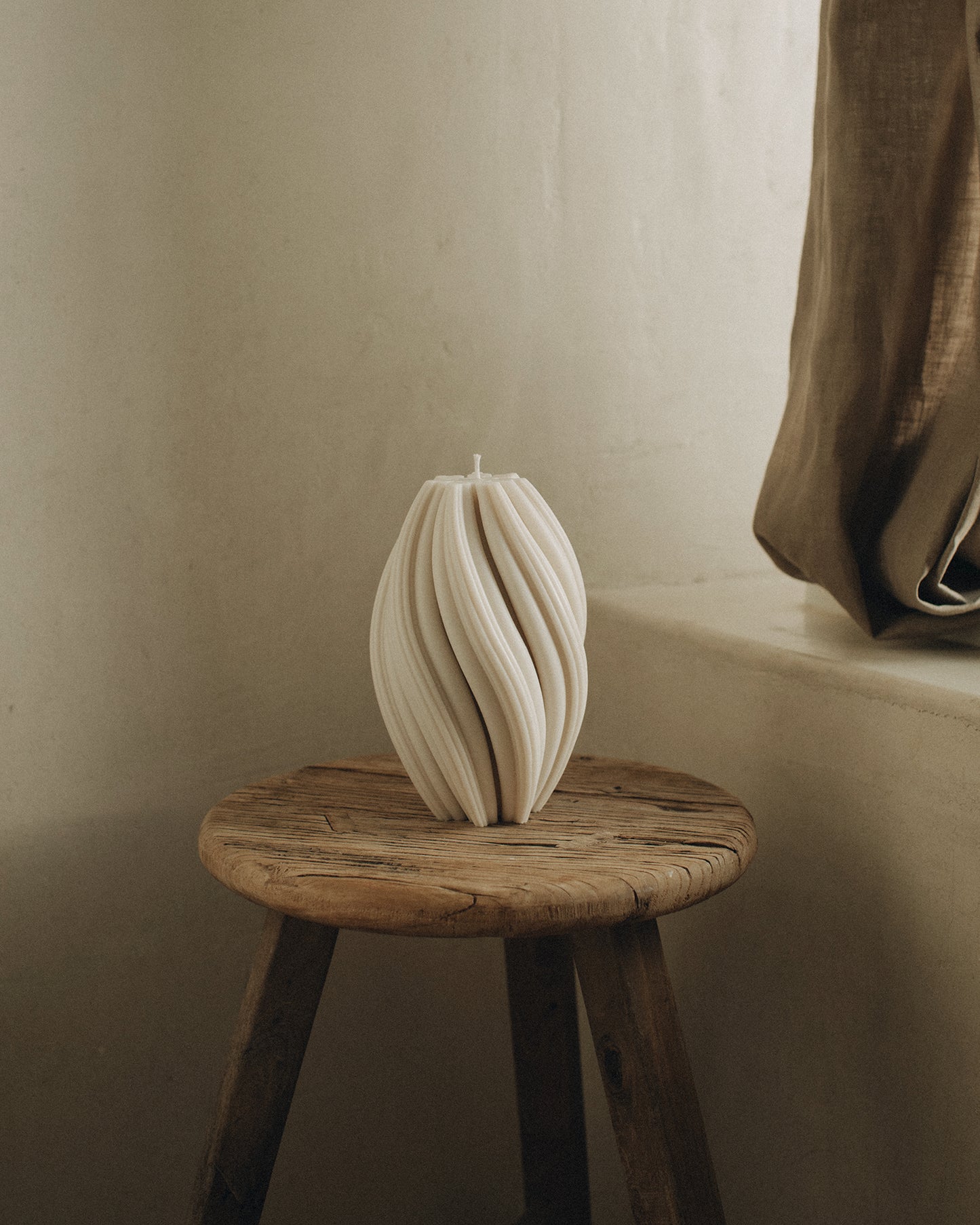 LAWA Candles Swirl Candle, large, in White soy wax styled in a home decor setting
