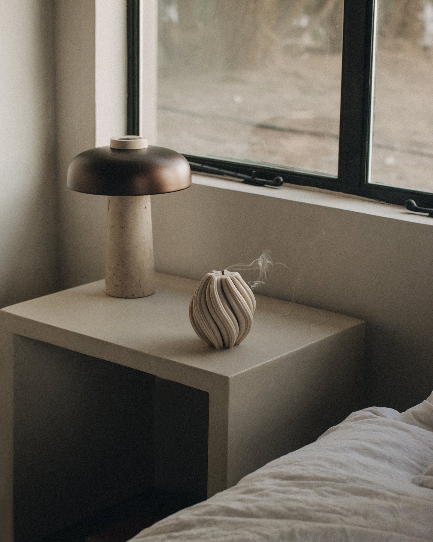 LAWA Candles Swirl Candle, medium, in Moon Gray soy wax styled in a home decor setting, alternate angle