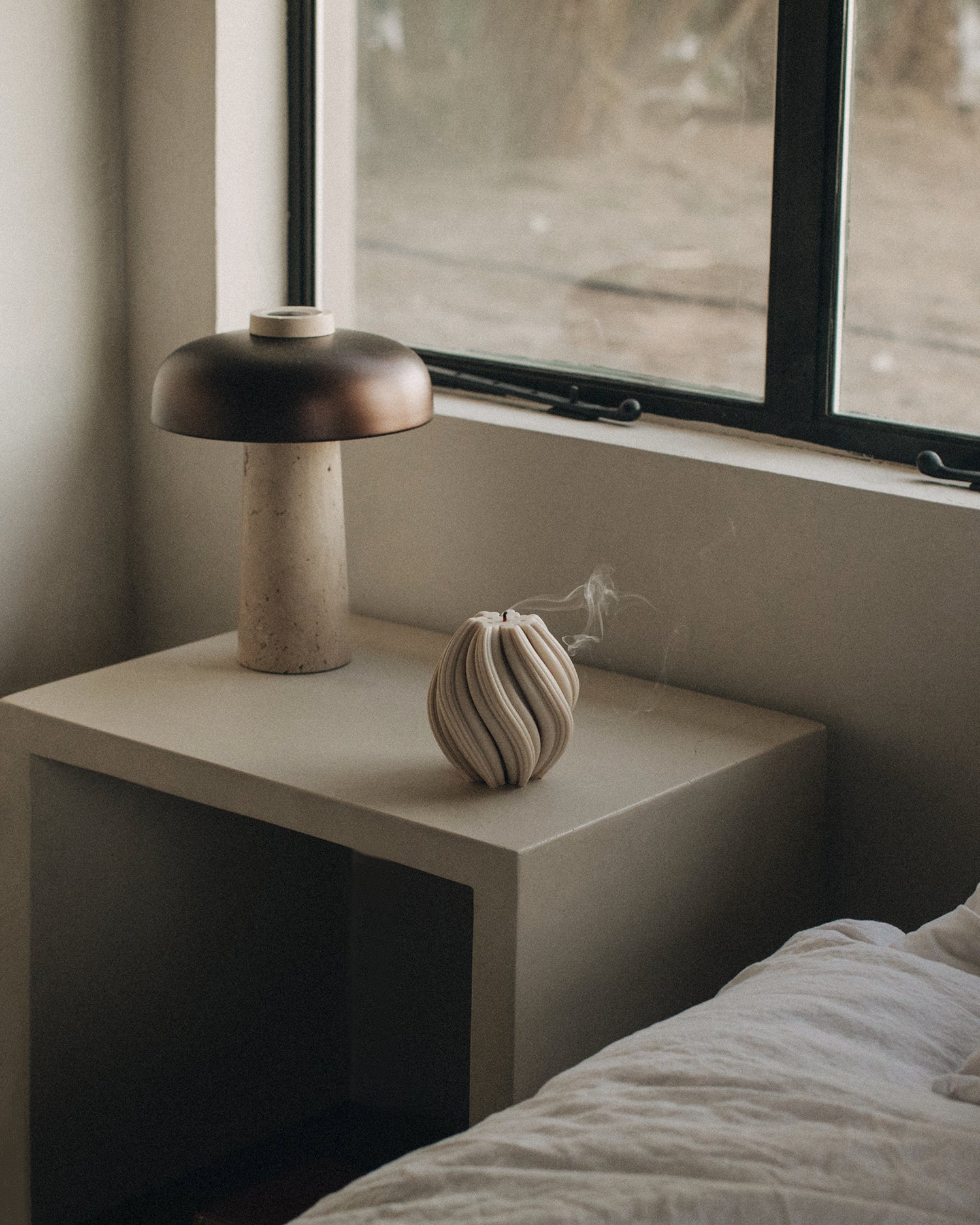LAWA Candles Swirl Candle, medium, in Moon Gray soy wax styled in a home decor setting, alternate angle