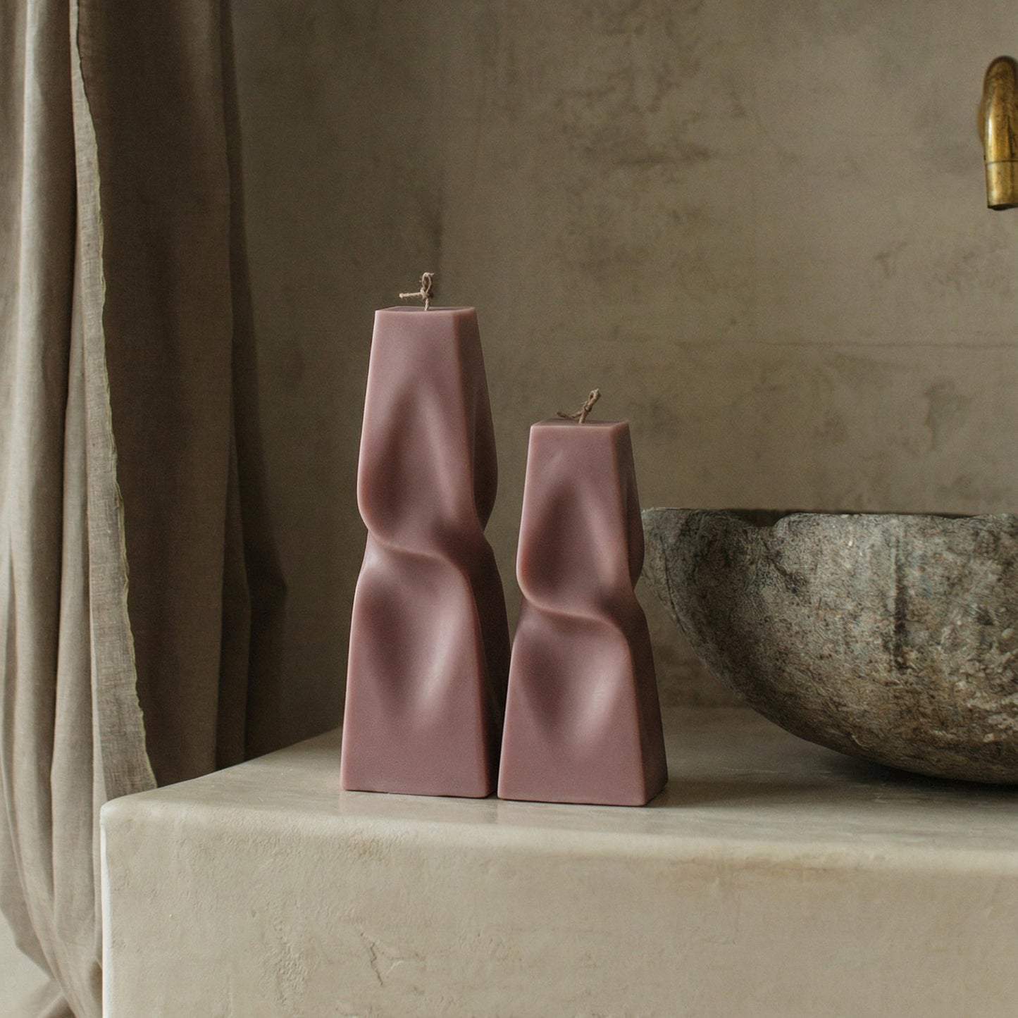 Close-up detail of handmade twisted pyramid sculptural candle showing premium soy wax texture and geometric form
