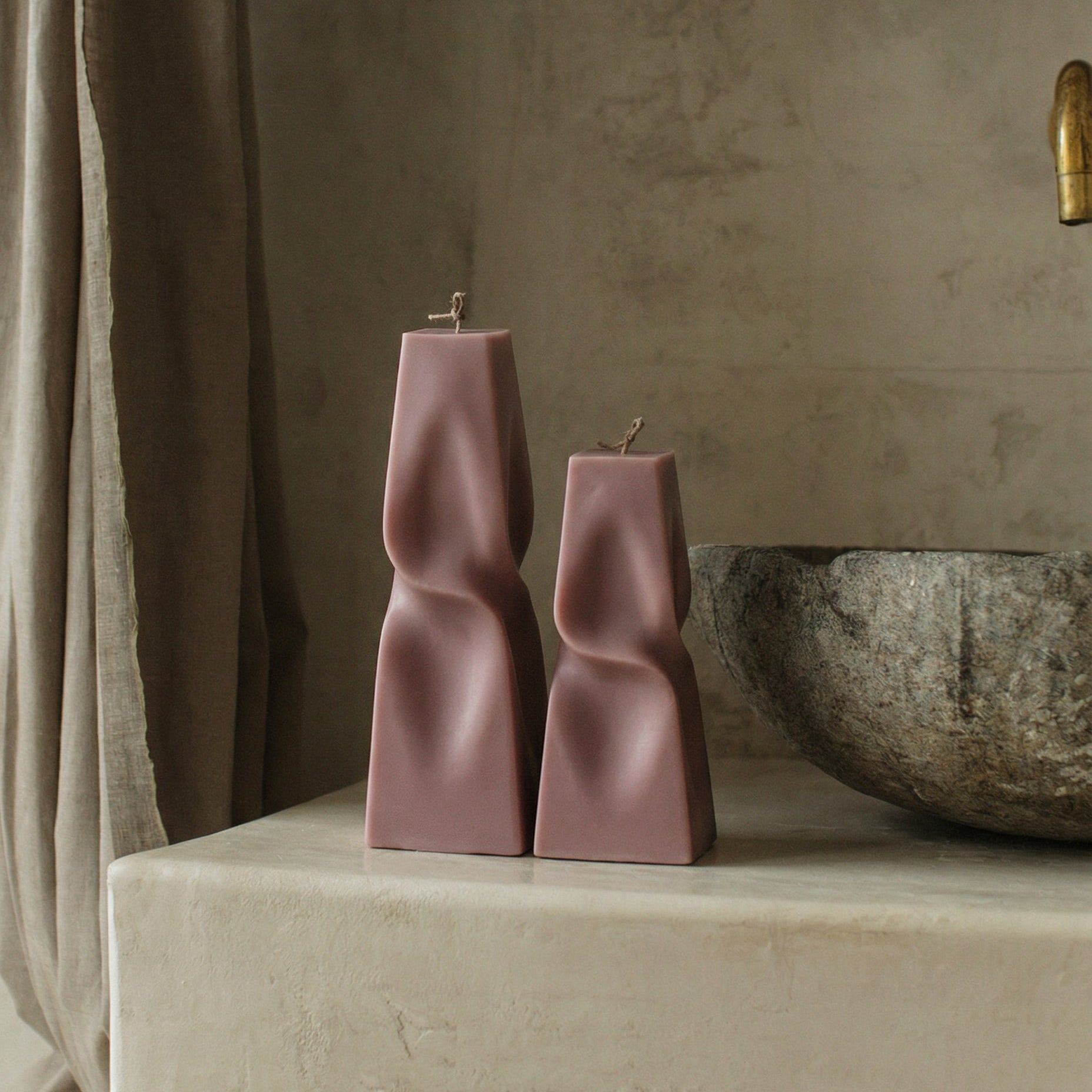 Close-up detail of handmade twisted pyramid sculptural candle showing premium soy wax texture and geometric form