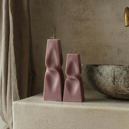 Close-up detail of handmade twisted pyramid sculptural candle showing premium soy wax texture and geometric form
