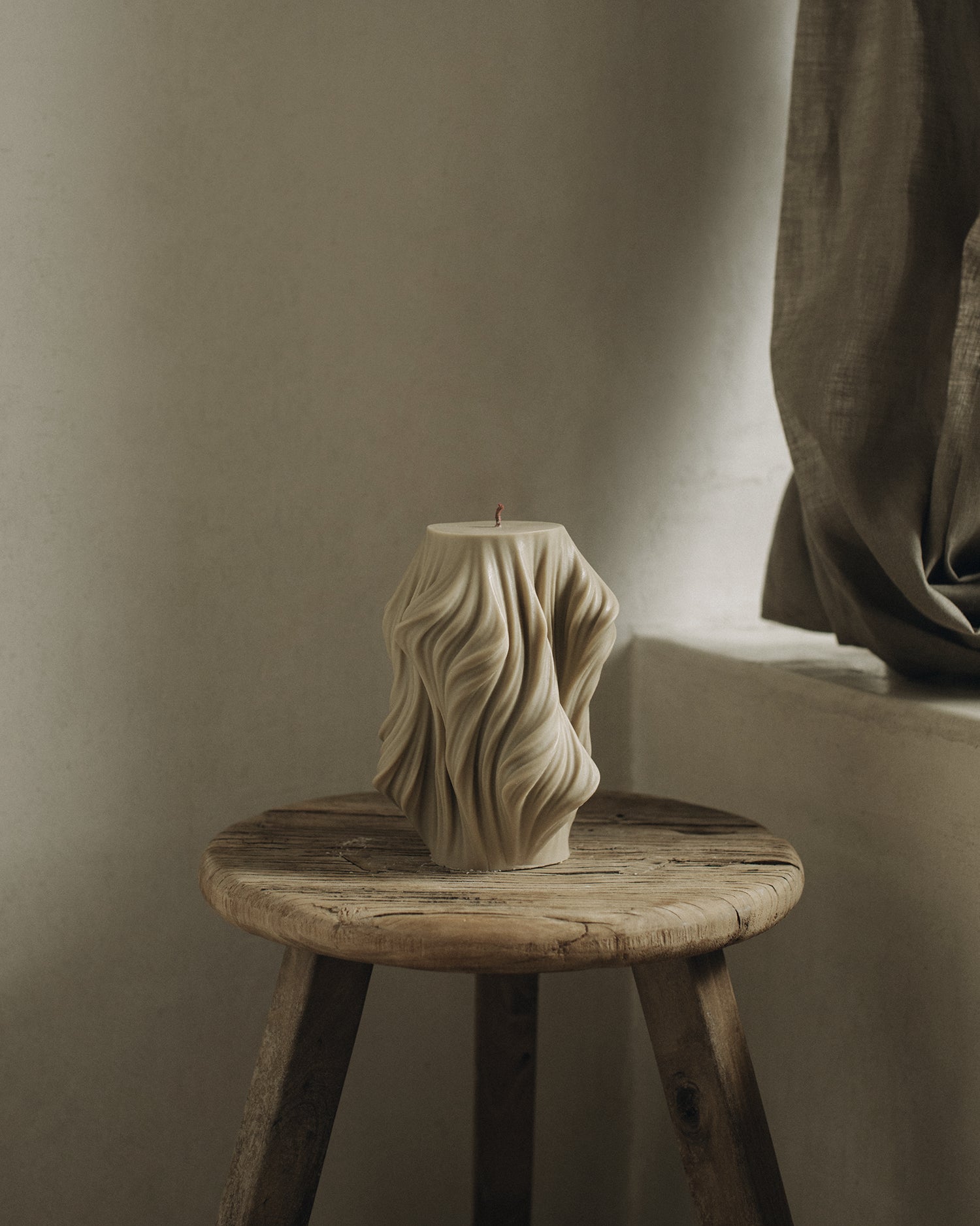 LAWA Candles Cascading Wave Candle, large, in Olive Beige soy wax styled in a home decor setting