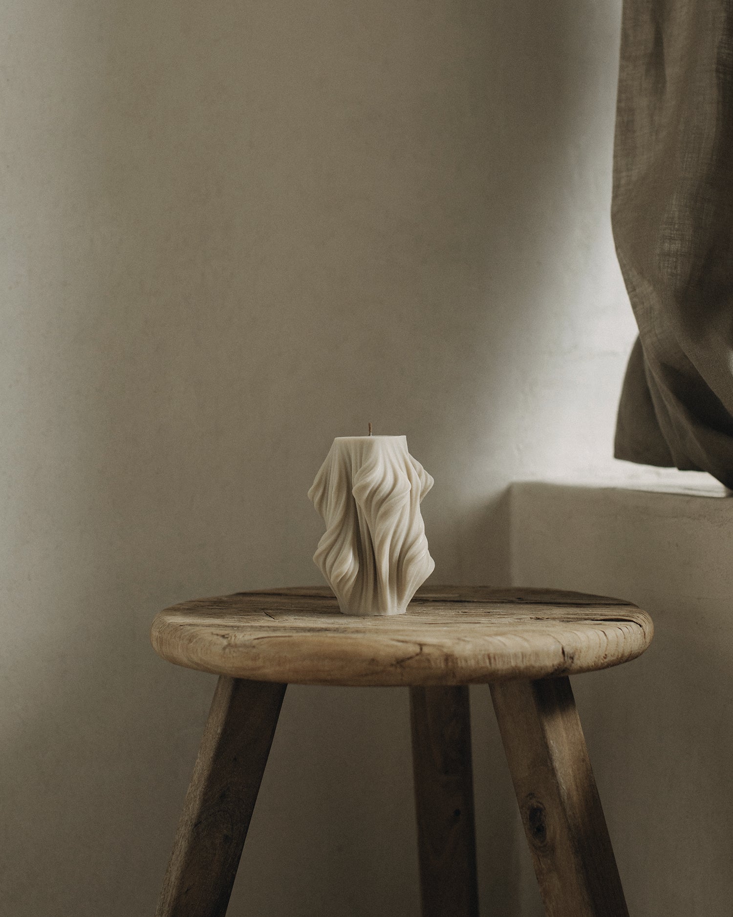 LAWA Candles Cascading Wave Candle, small, in Moon Gray soy wax styled in a home decor setting