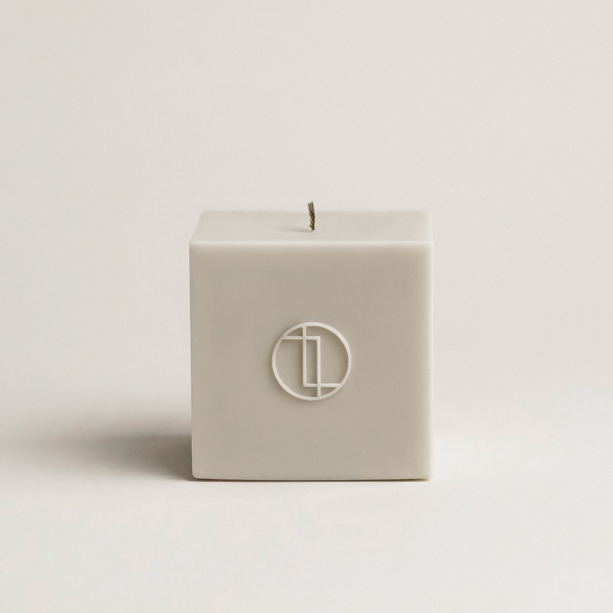 Minimalist block sculptural candle in white soy wax handmade in Los Angeles on neutral background