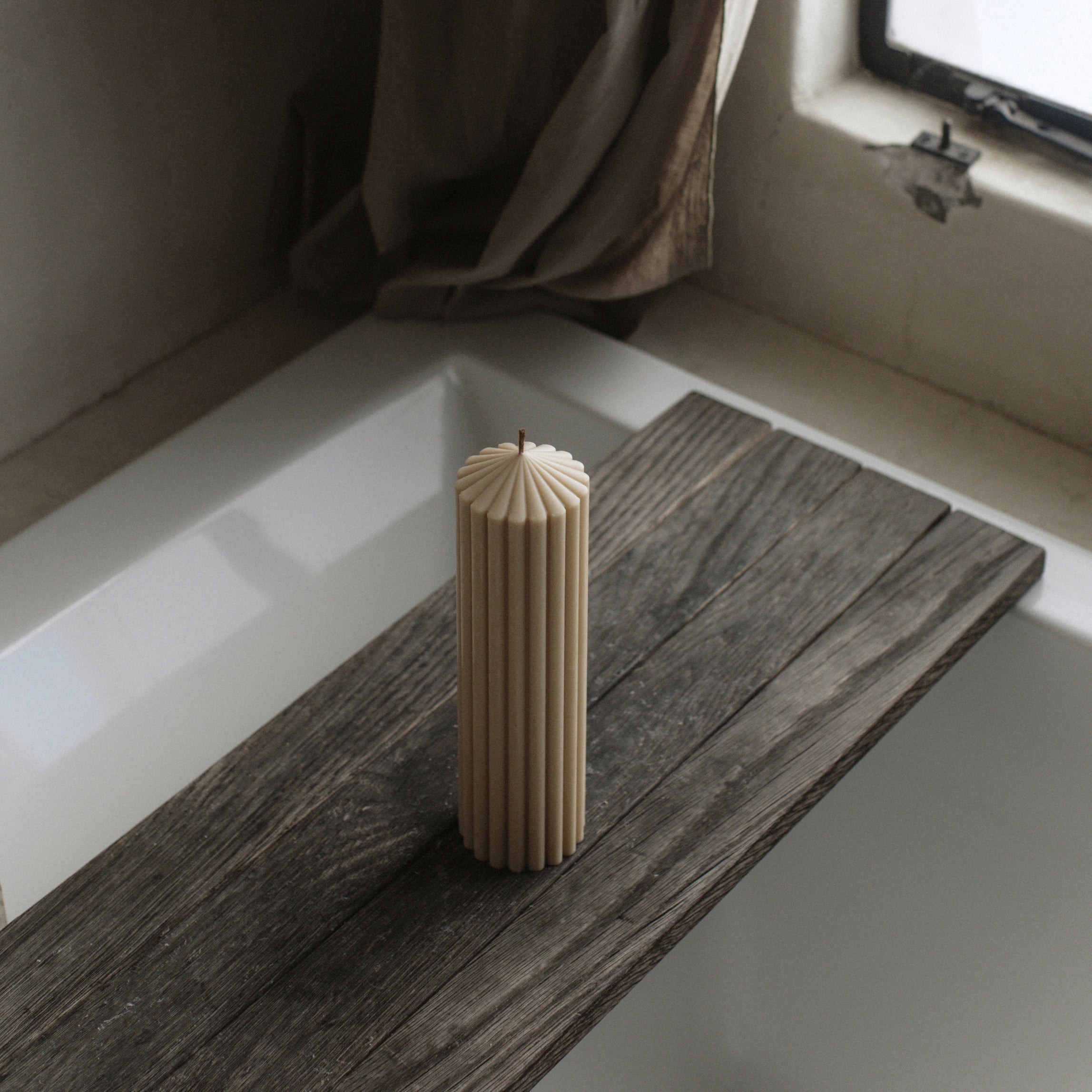 LAWA large sandstone soy wax peak candle featuring sculptural geometric height on a wooden surface with a neutral background