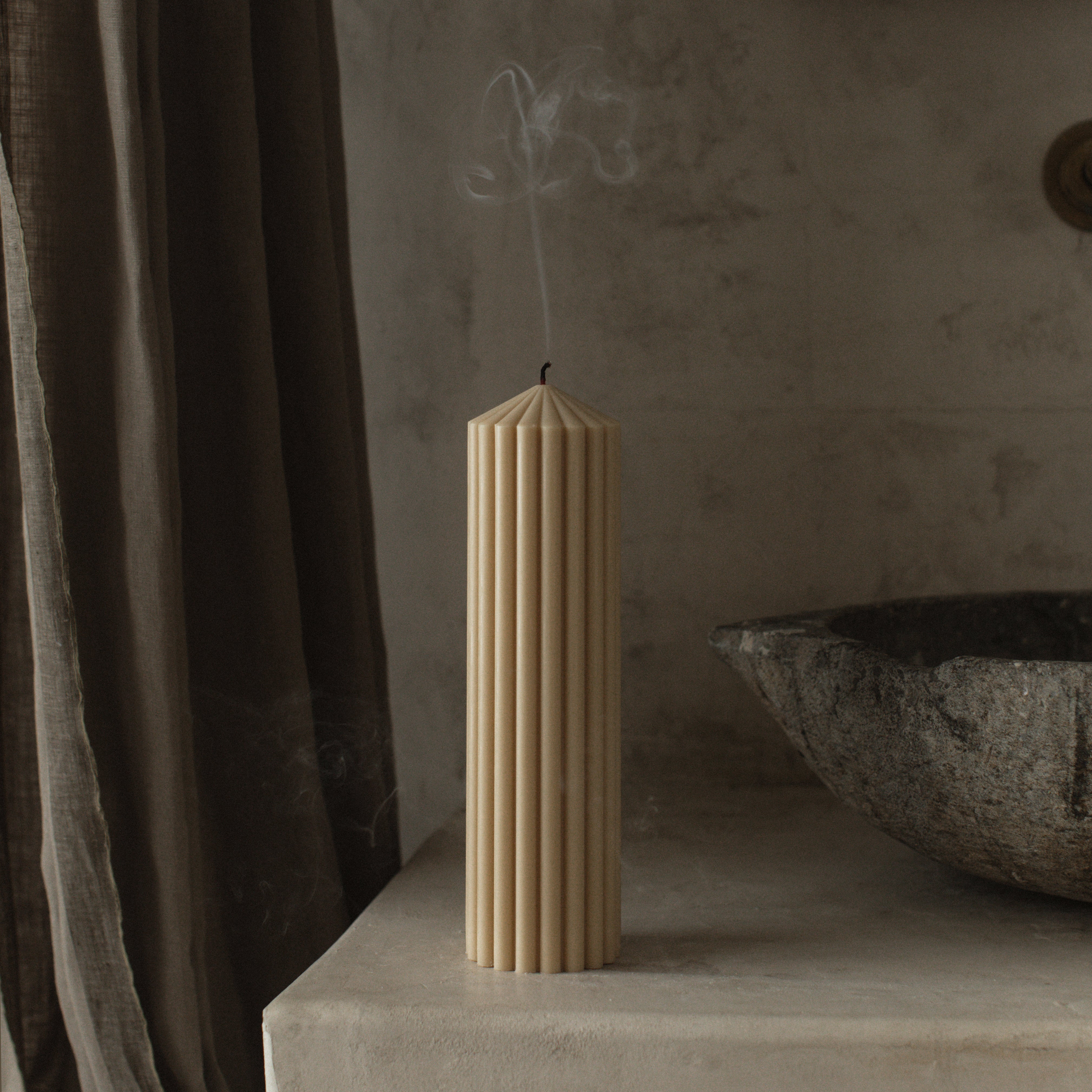 Sandstone large peak candle by LAWA with clean architectural mountain-inspired design on a stone surface with a blurred background