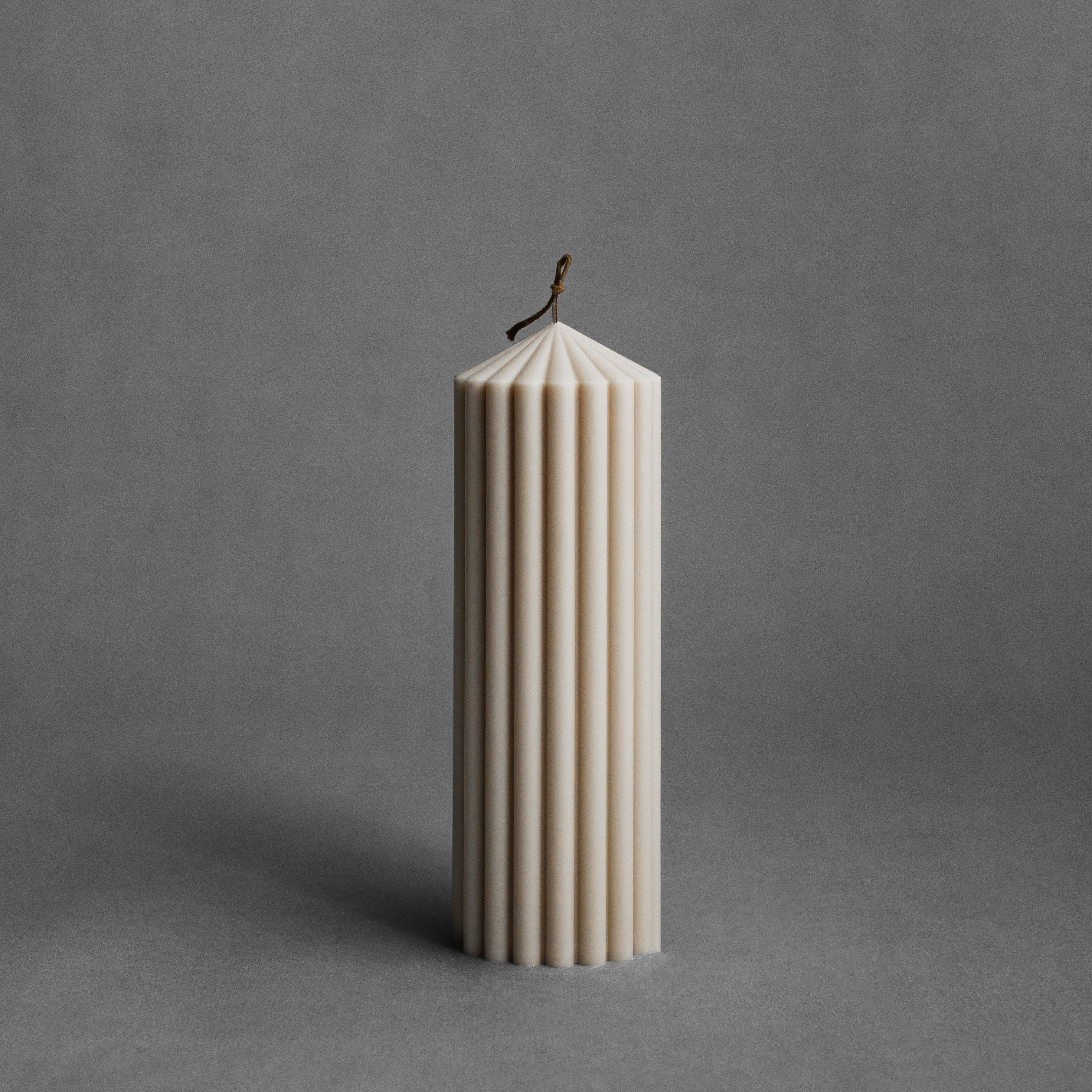 Medium moon gray peak pillar candle by LAWA with tall sculptural pointed silhouette