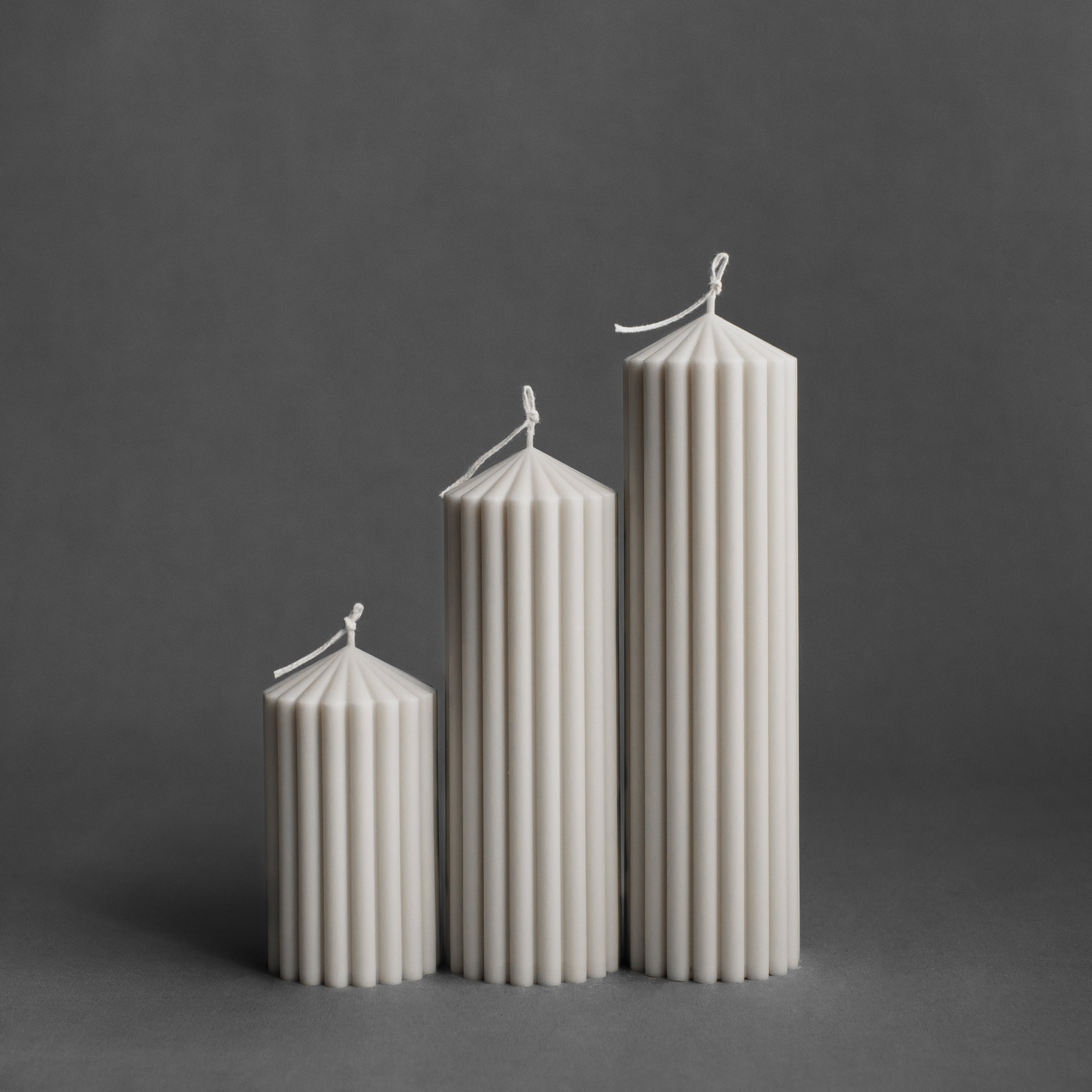 Set of three white peak pillar candles by LAWA in small, medium, and large sizes