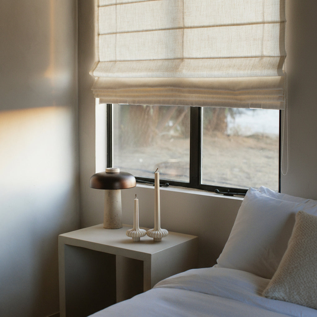 Moon Gray pumpkin-inspired candle base by LAWA made from clean soy wax in a Bedroom with a window, nightstand, and decorative items.