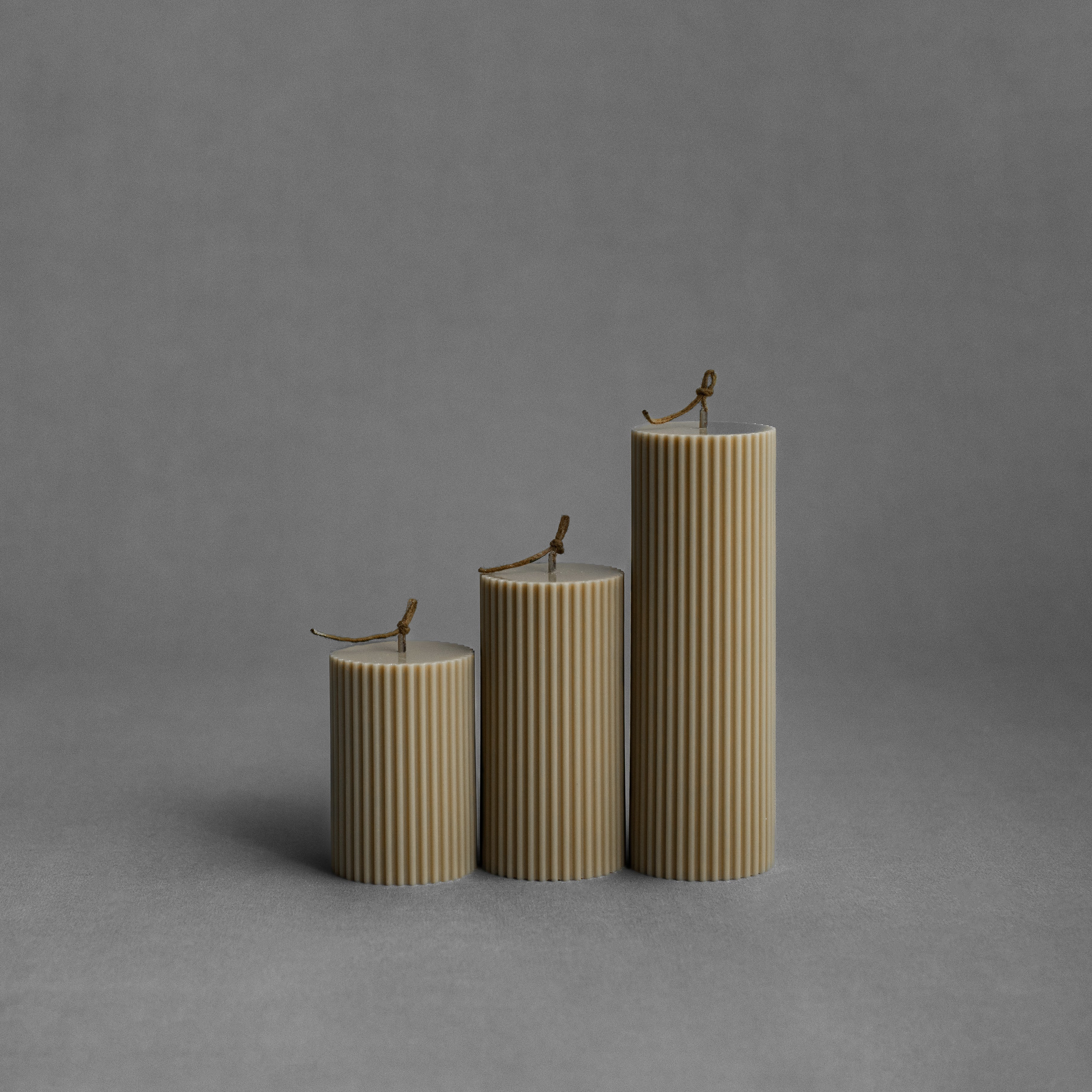 Olive beige ribbed pillar candle set by LAWA with earthy sculptural ribbing