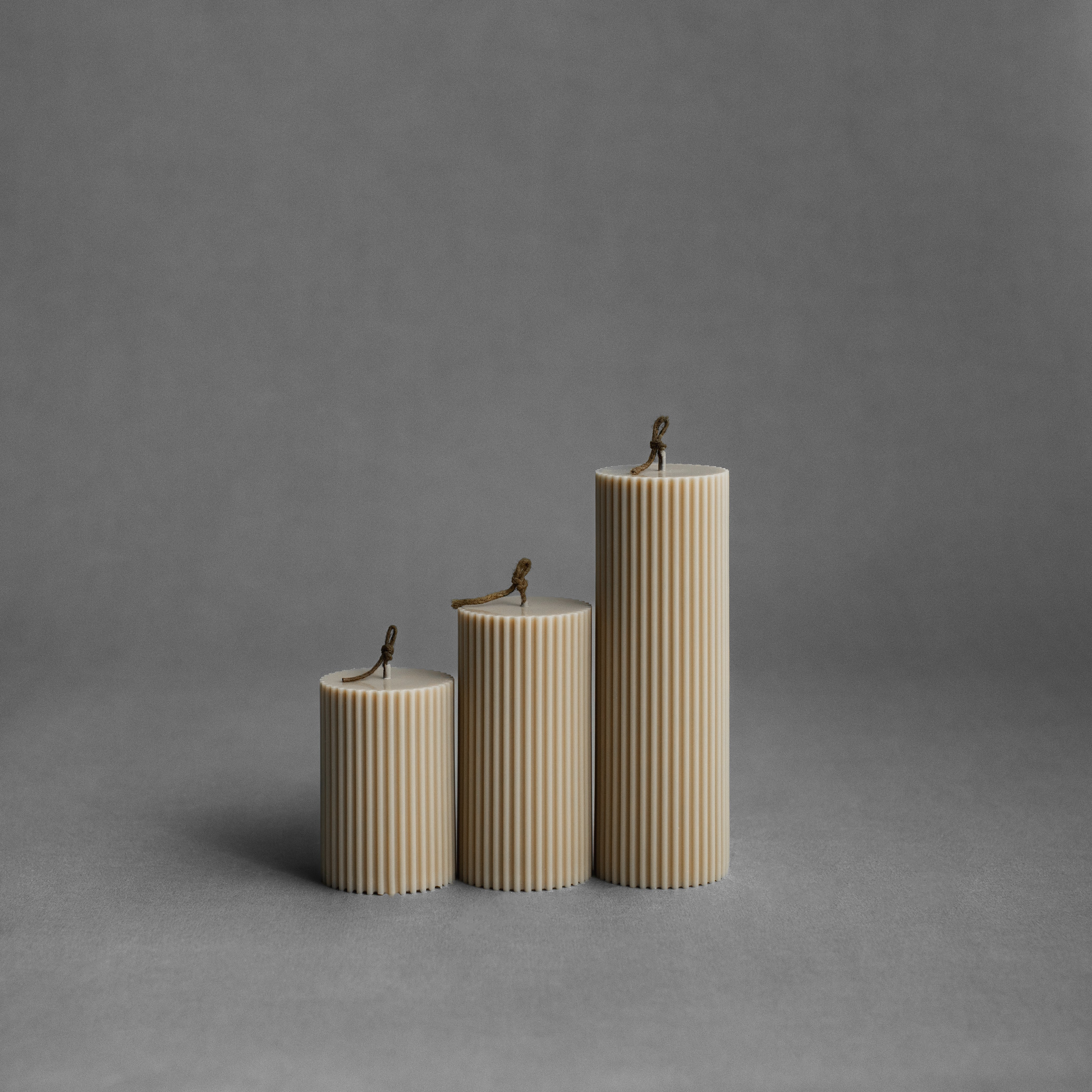 Sandstone ribbed pillar candle set by LAWA with warm neutral ribbed texture