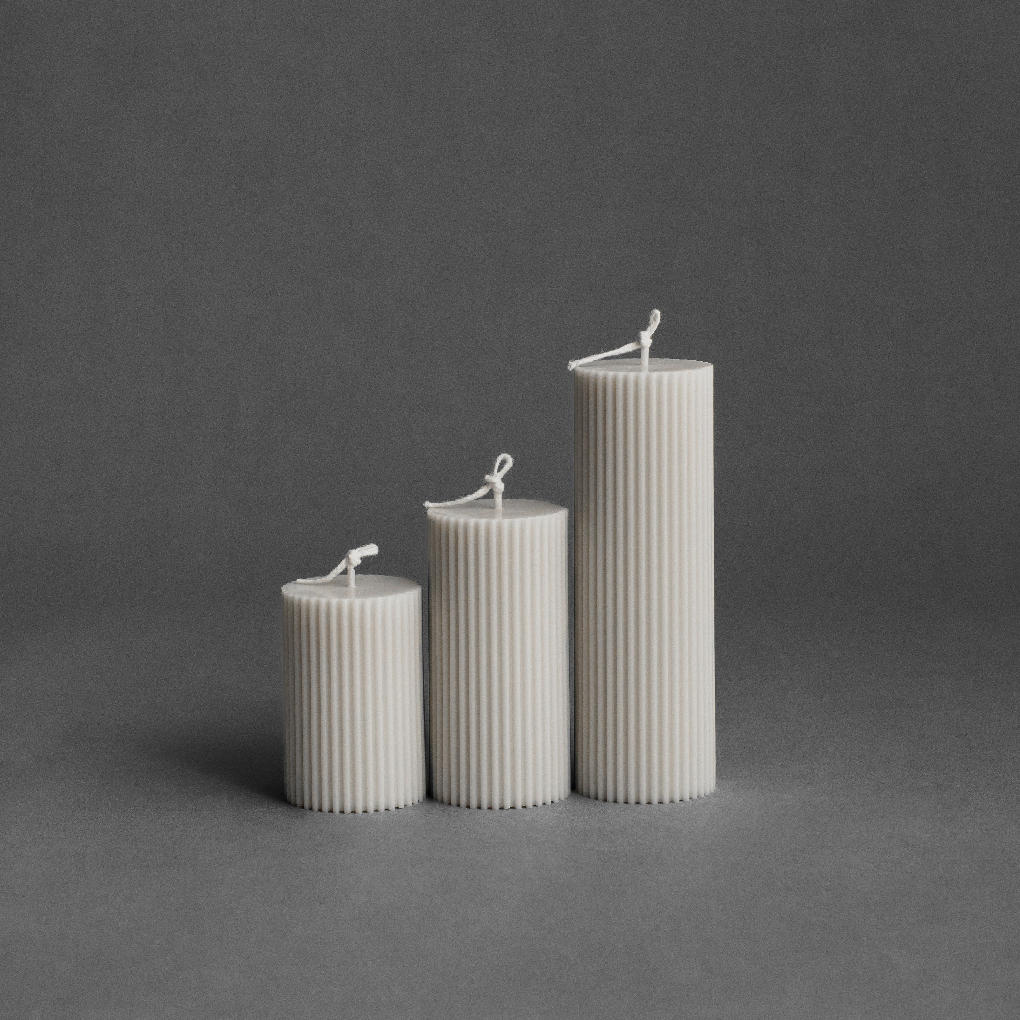 White ribbed pillar candle set by LAWA featuring two sculptural ribbed candles in soy wax