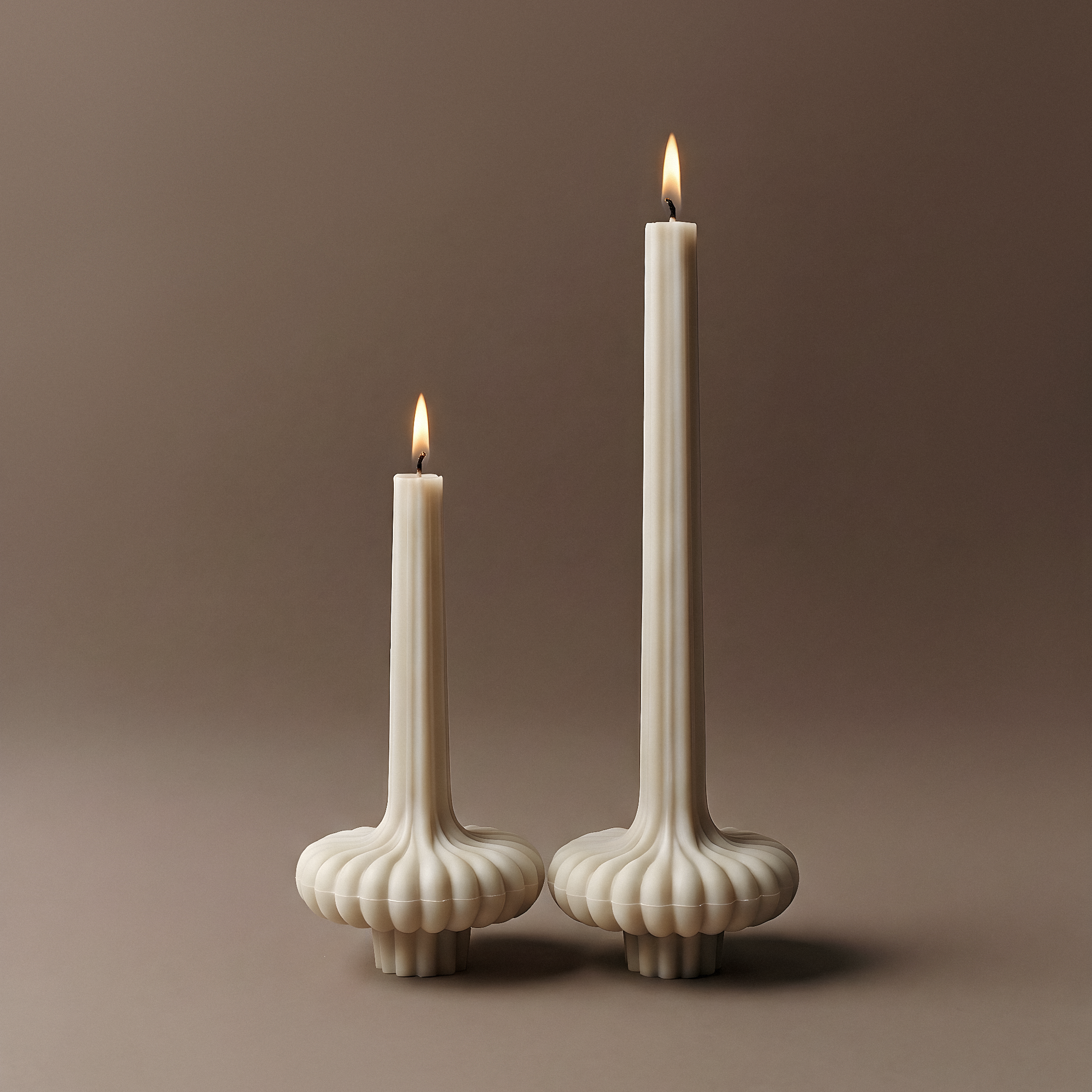 White sculptural pumpkin candle made from unscented soy wax on brown background