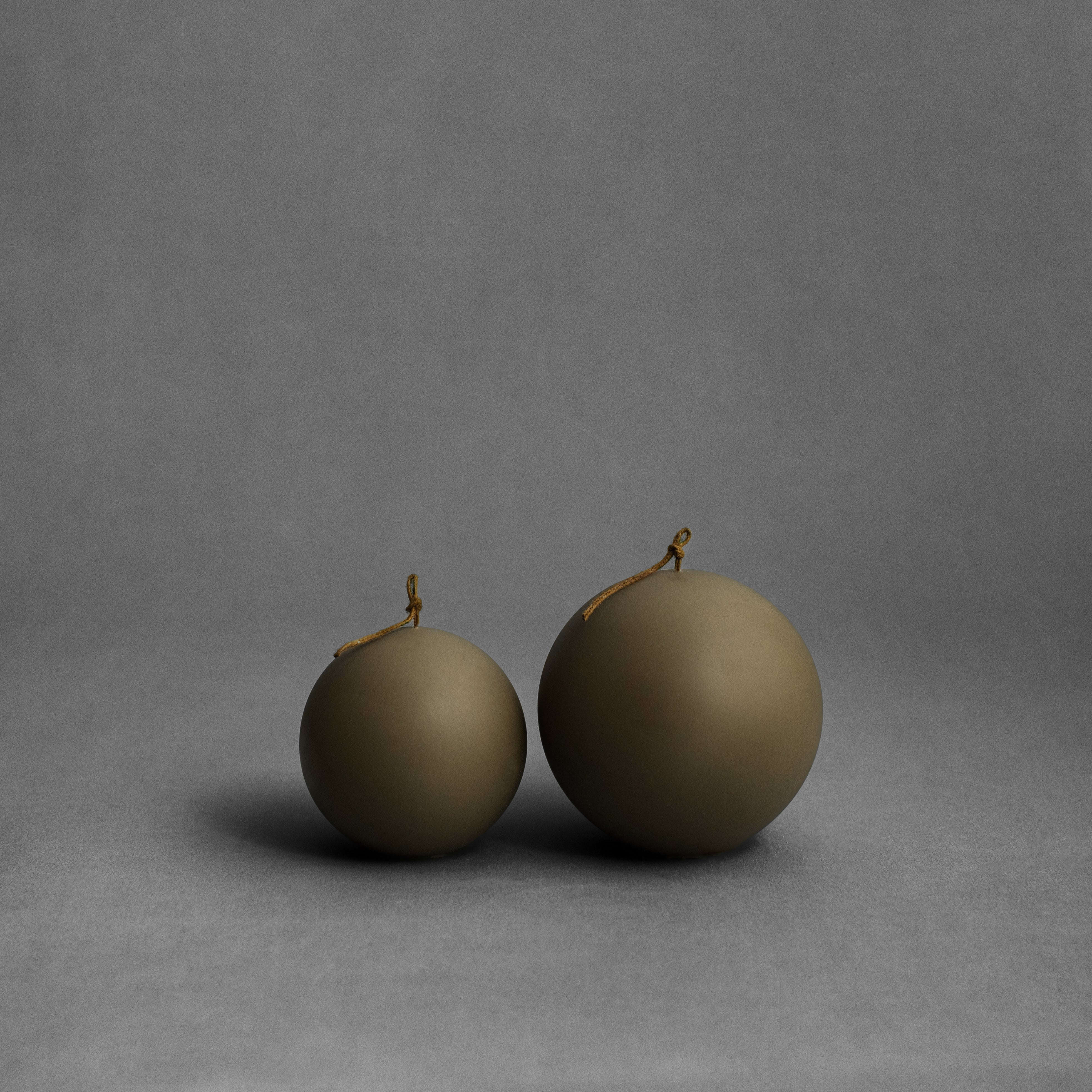 Earthy green sphere pillar candle set by LAWA with sculptural rounded shapes for modern natural decor