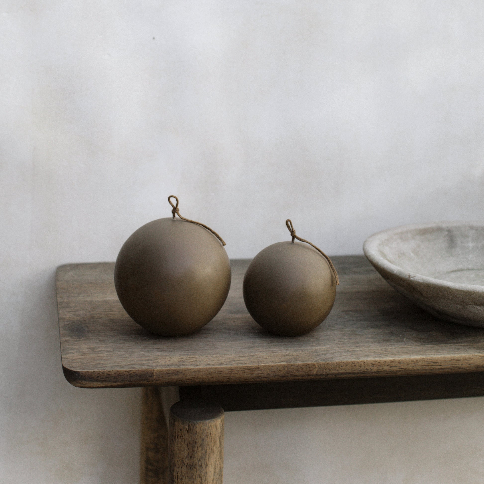 Handmade sculptural sphere candle in Los Angeles studio with artisan tools and premium soy wax materials in detail