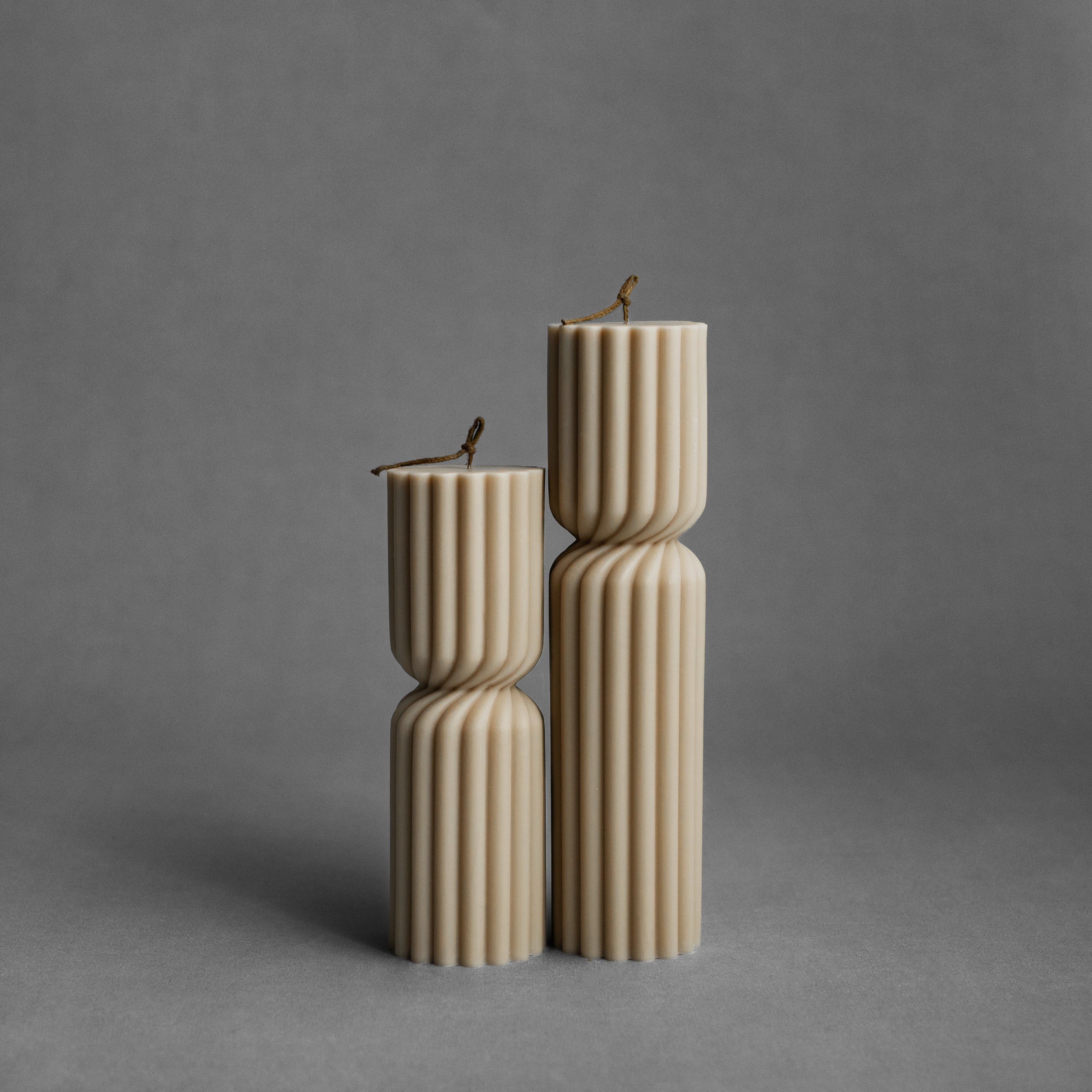 Sandstone spiral spire pillar candle set by LAWA with warm, twisted sculptural detailing