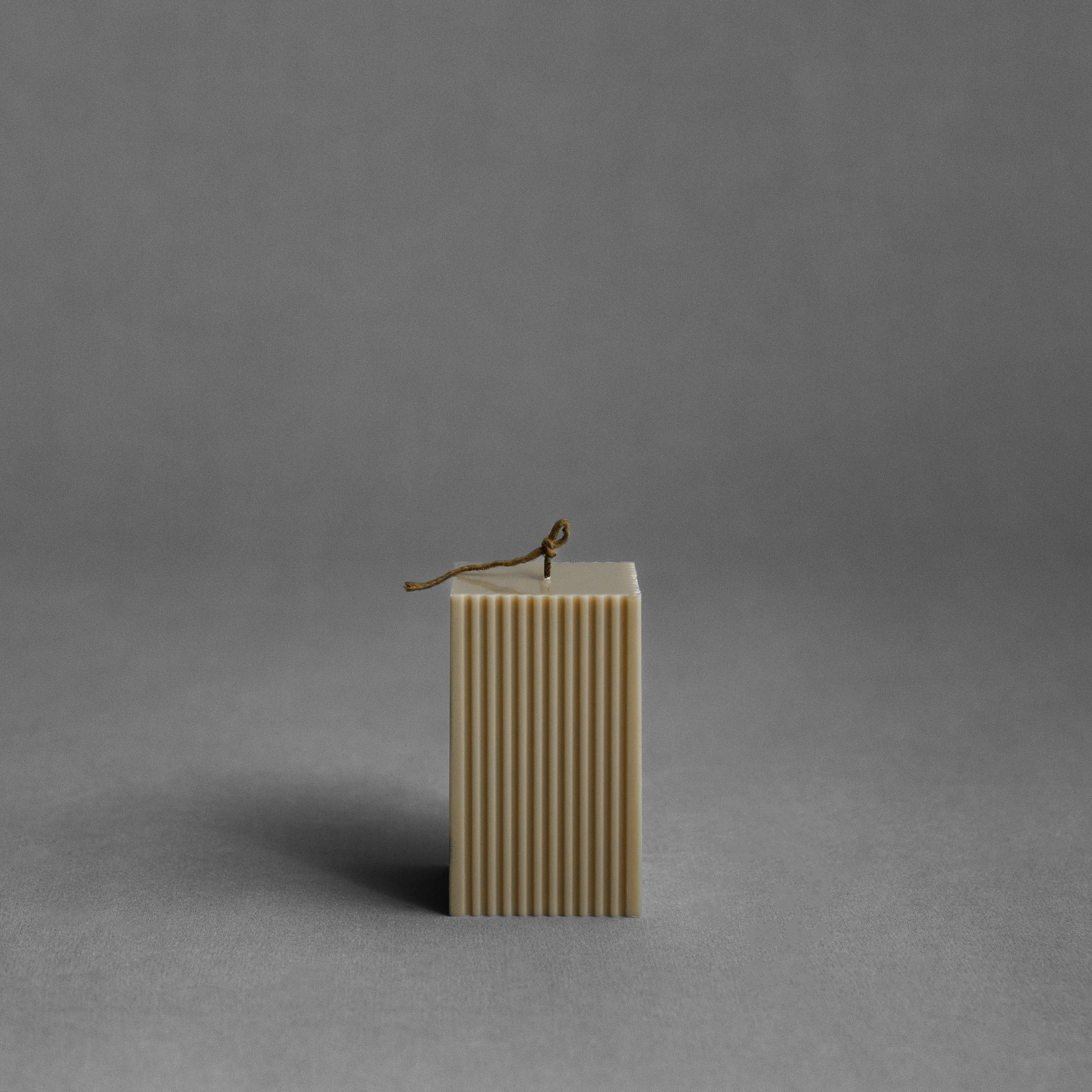Olive beige square ribbed pillar candle by LAWA with sculptural vertical texture