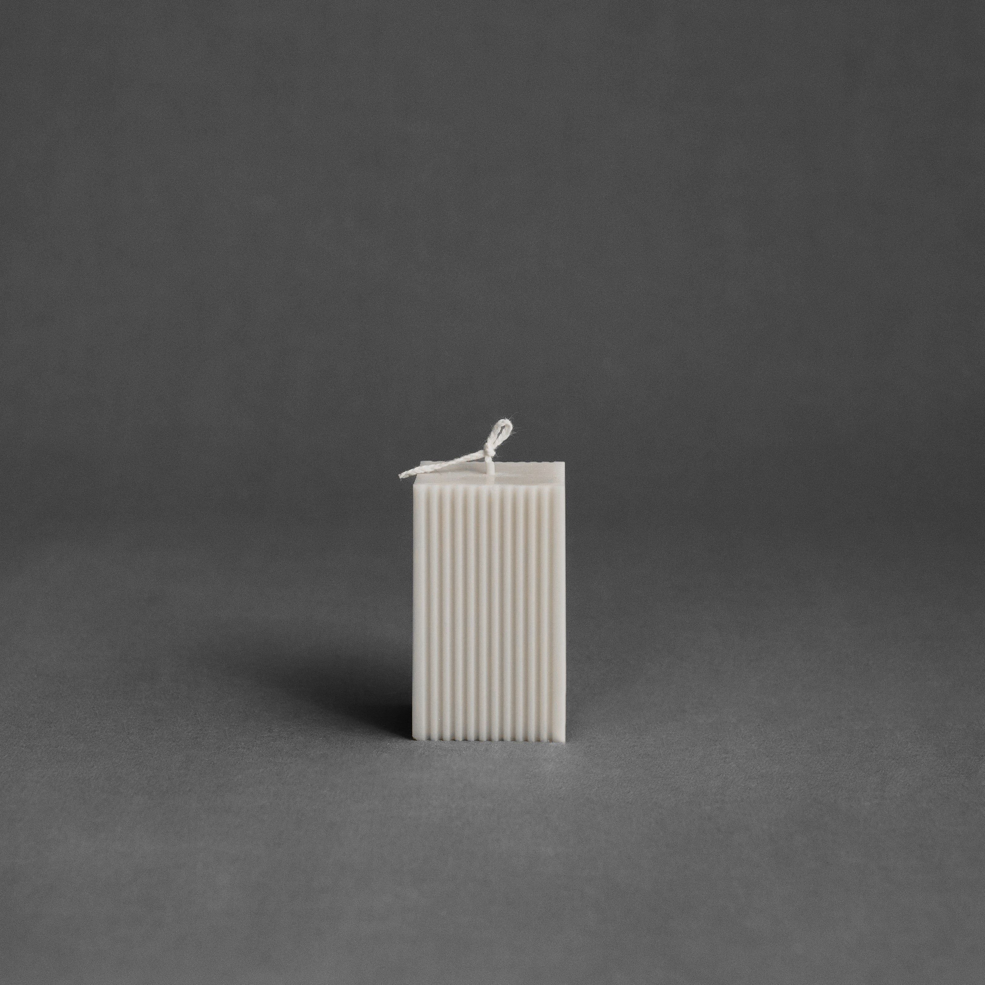 White square ribbed pillar candle by LAWA with clean vertical lines in soy wax