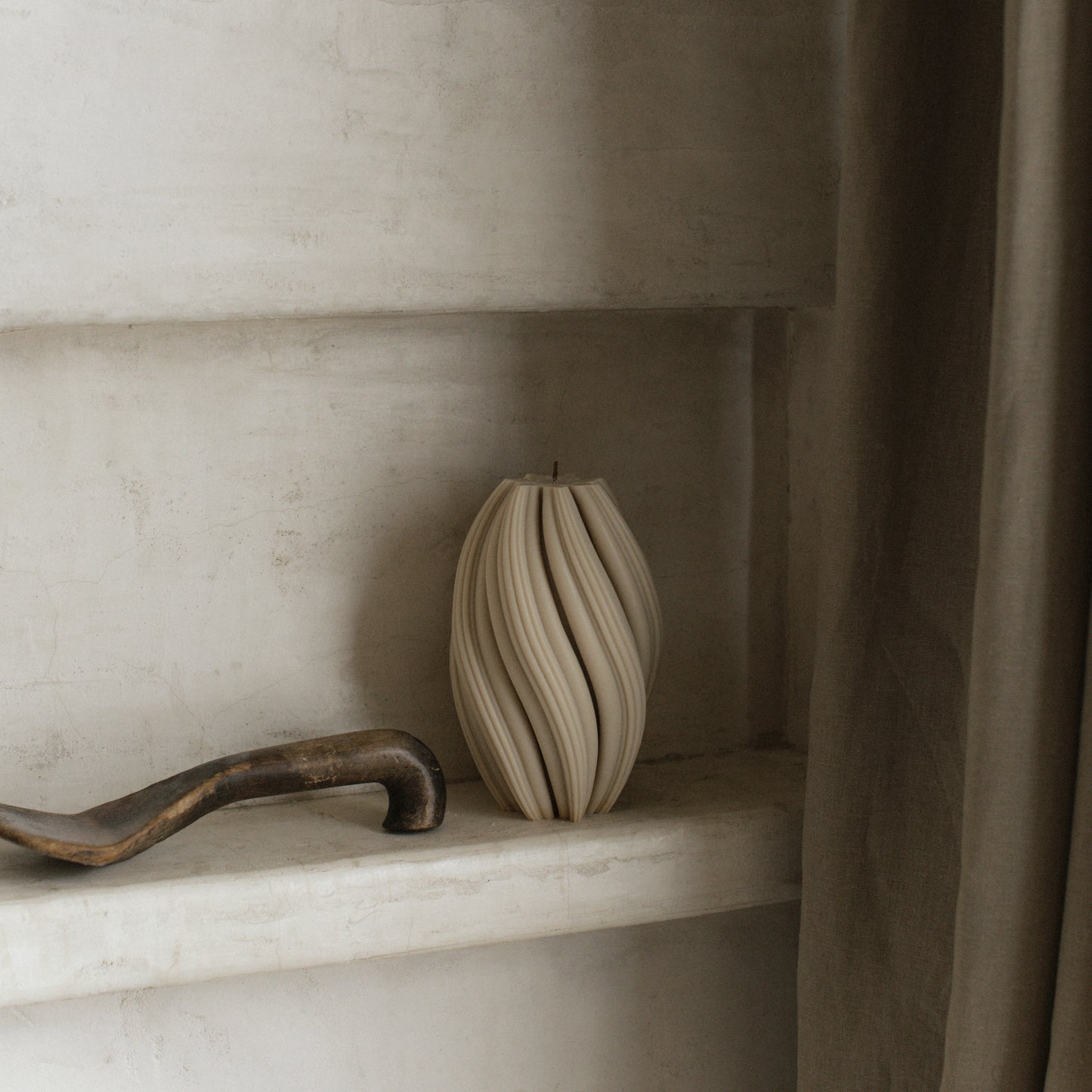 Close-up detail of handmade sculptural swirl candle showing premium soy wax texture and organic curves