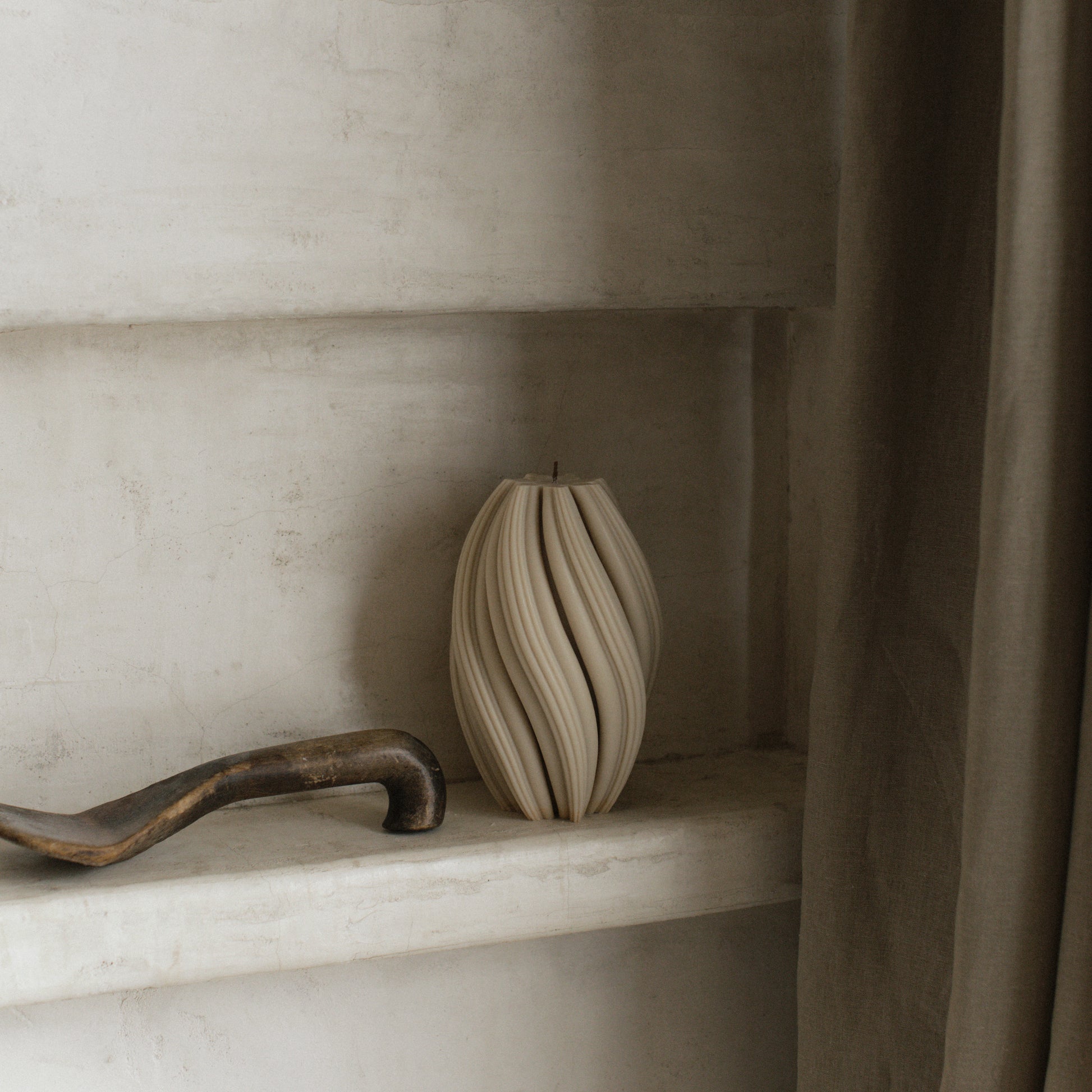 Close-up detail of handmade sculptural swirl candle showing premium soy wax texture and organic curves