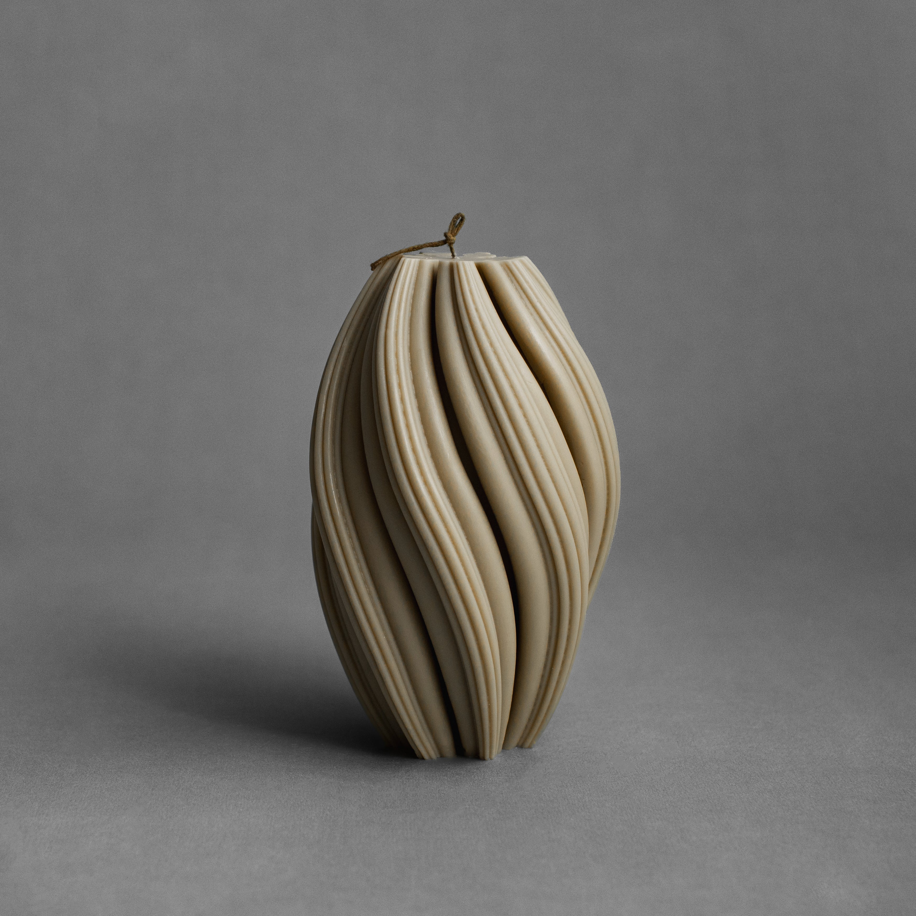 Large olive beige swirl pillar candle by LAWA with bold sculptural spiral pattern