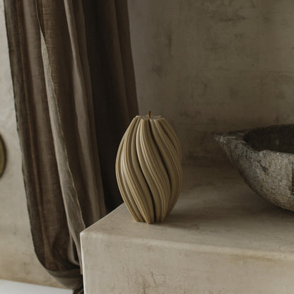 Close-up detail of handmade sculptural swirl candle showing premium soy wax texture and organic curved ridges