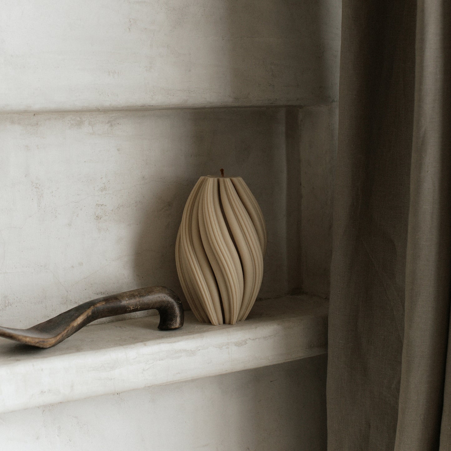 Handmade swirl sculptural candle detail showing premium soy wax texture in minimalist Los Angeles studio setting