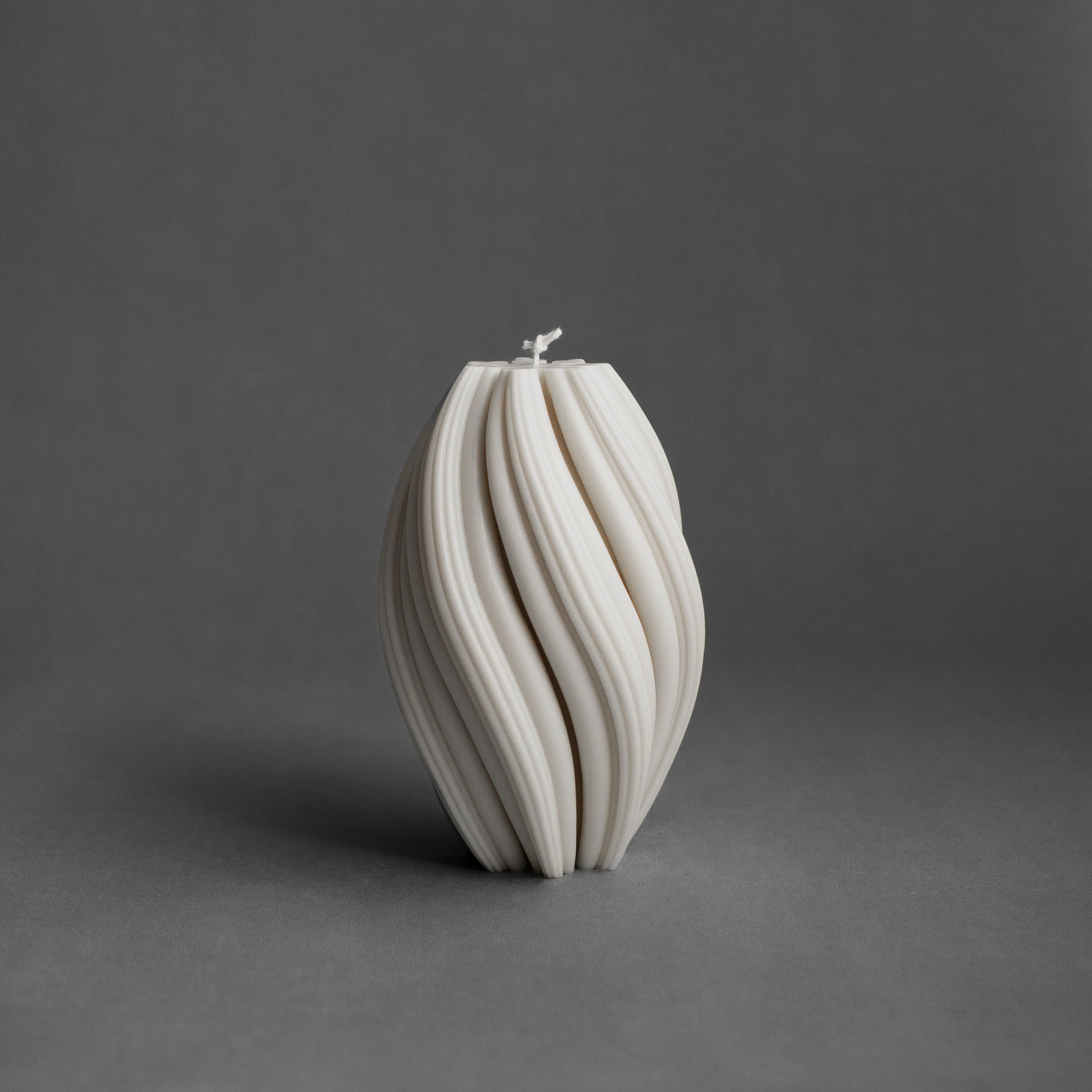 Large white swirl pillar candle by LAWA with bold spiraling sculptural pattern