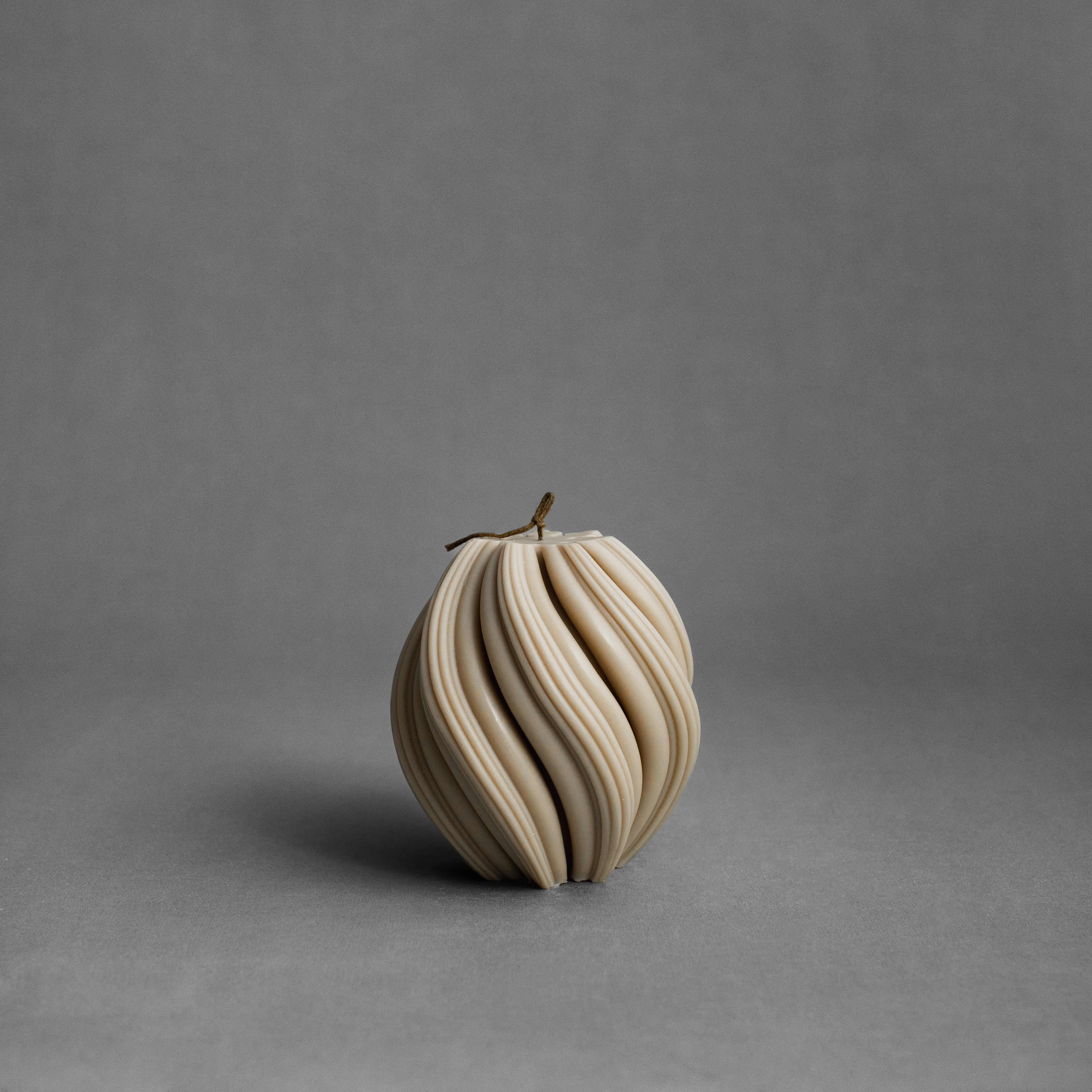 Medium sandstone swirl pillar candle by LAWA with elegant spiraling sculptural form