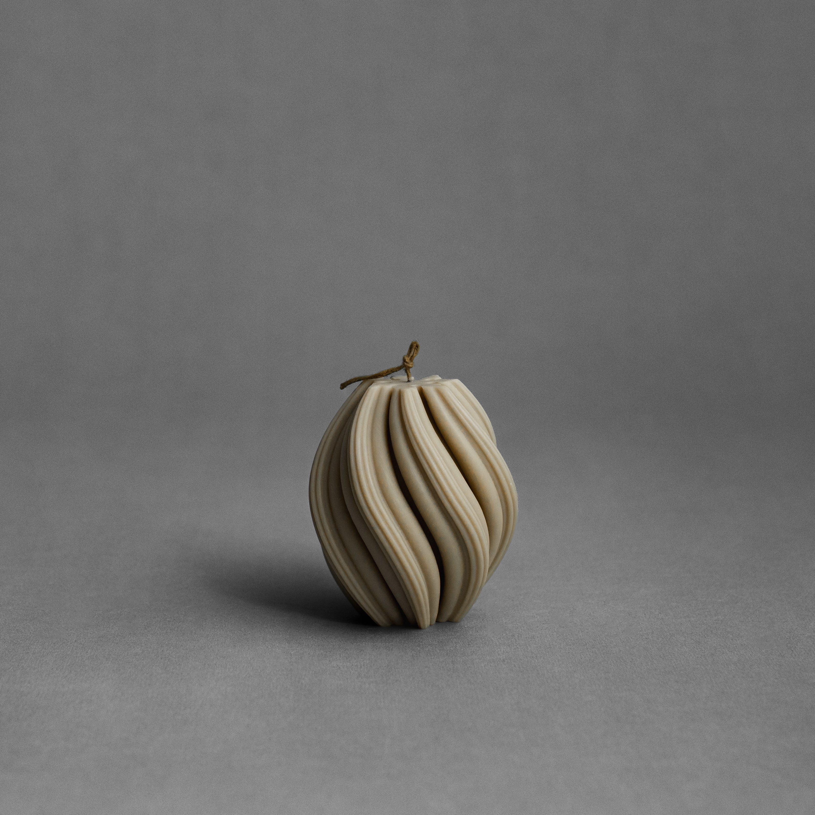 Small olive beige swirl pillar candle by LAWA with sculptural twisted spiral design