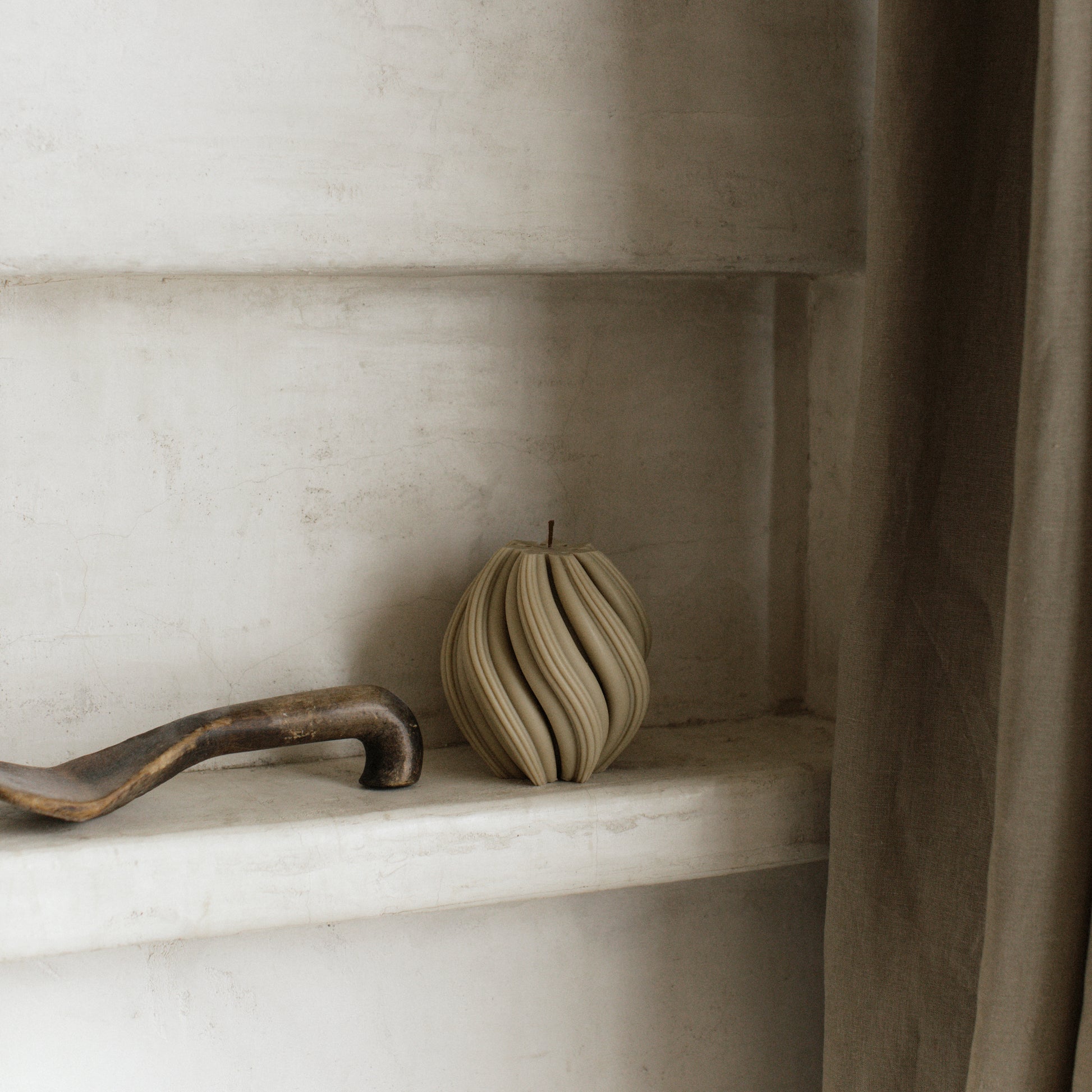 Close-up detail of handmade sculptural swirl candle showing premium soy wax texture and organic curves
