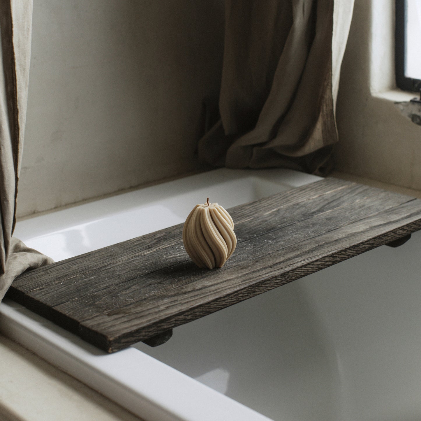 Handmade swirl sculptural candle detail showing smooth soy wax texture and organic curves in natural light