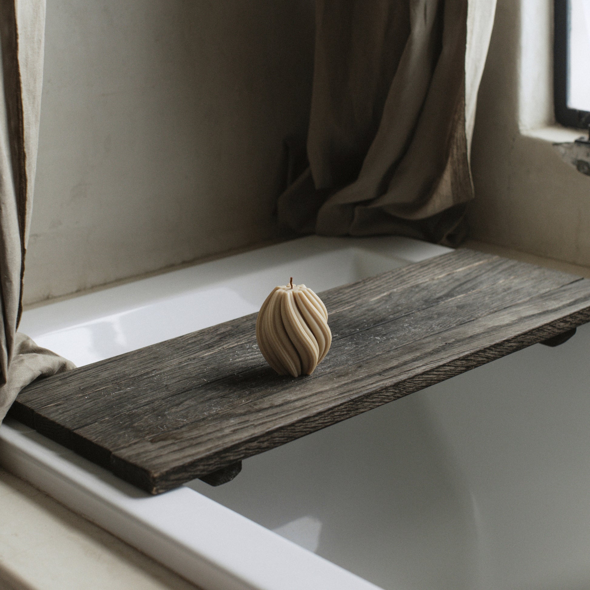Handmade swirl sculptural candle detail showing smooth soy wax texture and organic curves in natural light