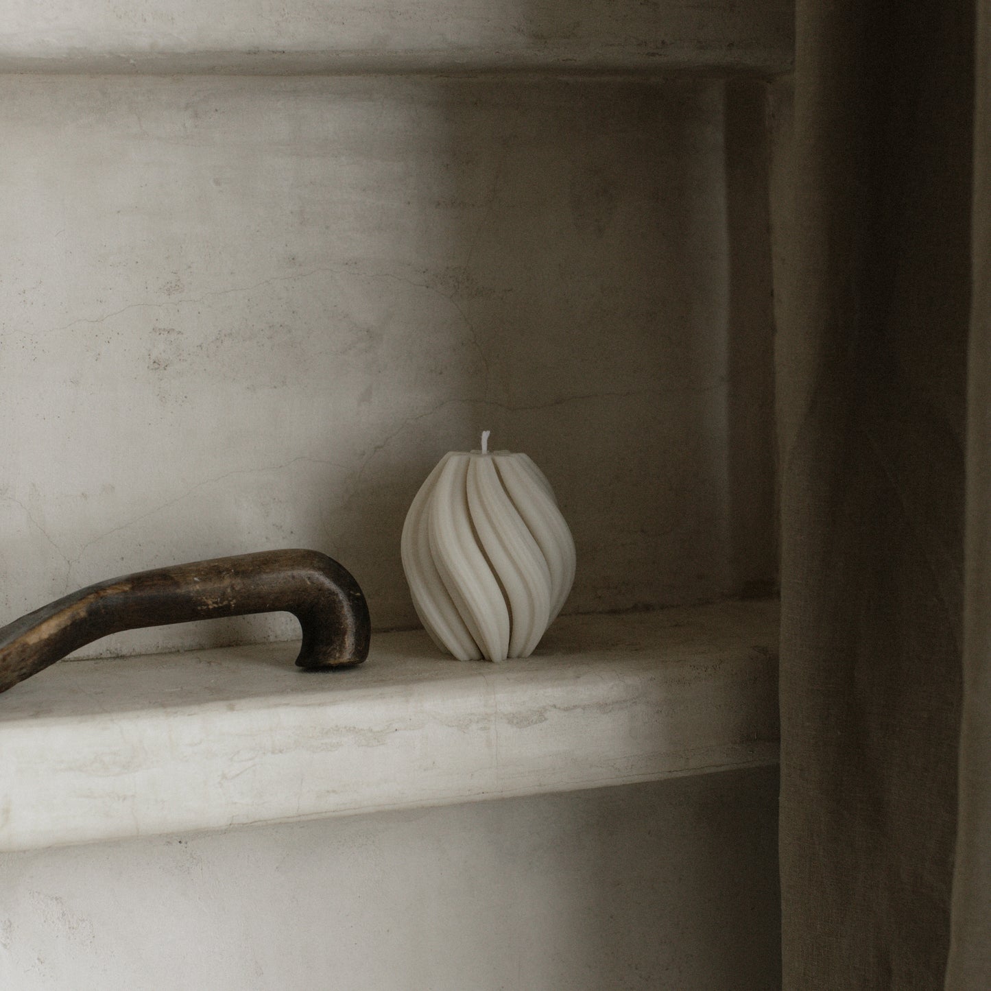 Handmade soy wax swirl sculptural candle detail showing organic texture and curves in natural light