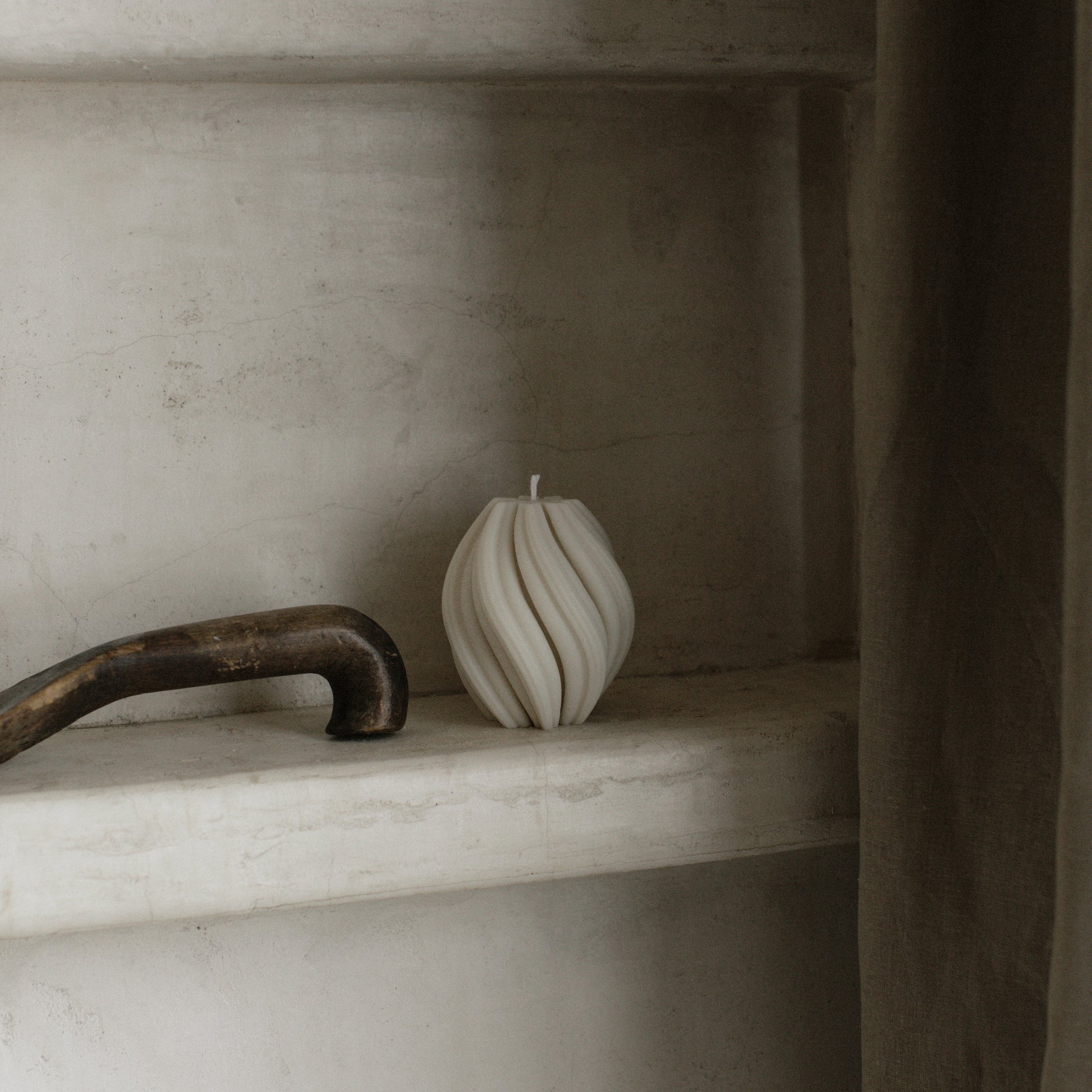 Handmade soy wax swirl sculptural candle detail showing organic texture and curves in natural light