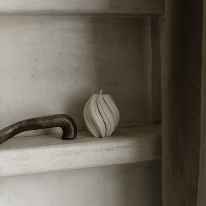 Handmade soy wax swirl sculptural candle detail showing organic texture and curves in natural light