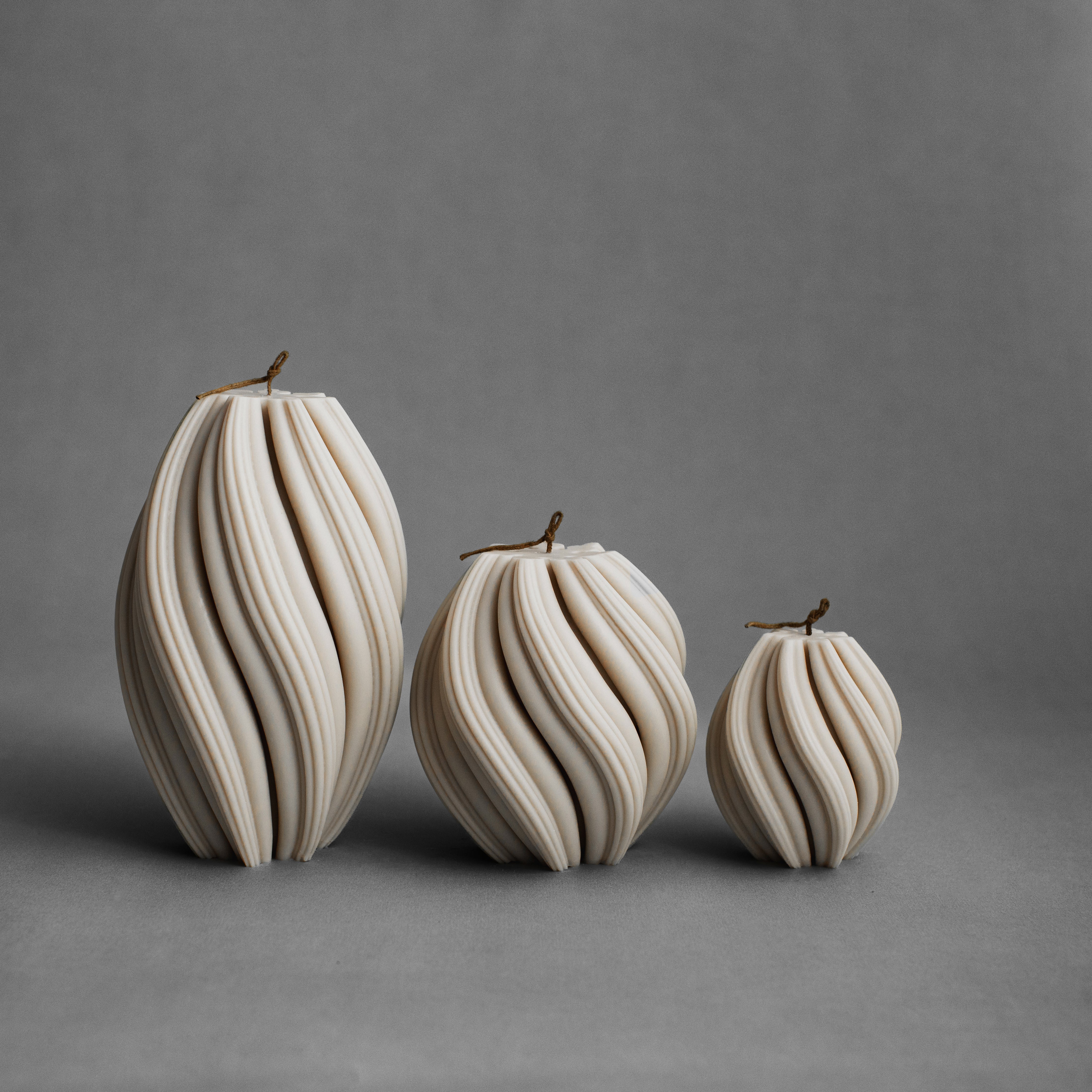 Set of three moon gray swirl pillar candles by LAWA in small, medium, and large sizes