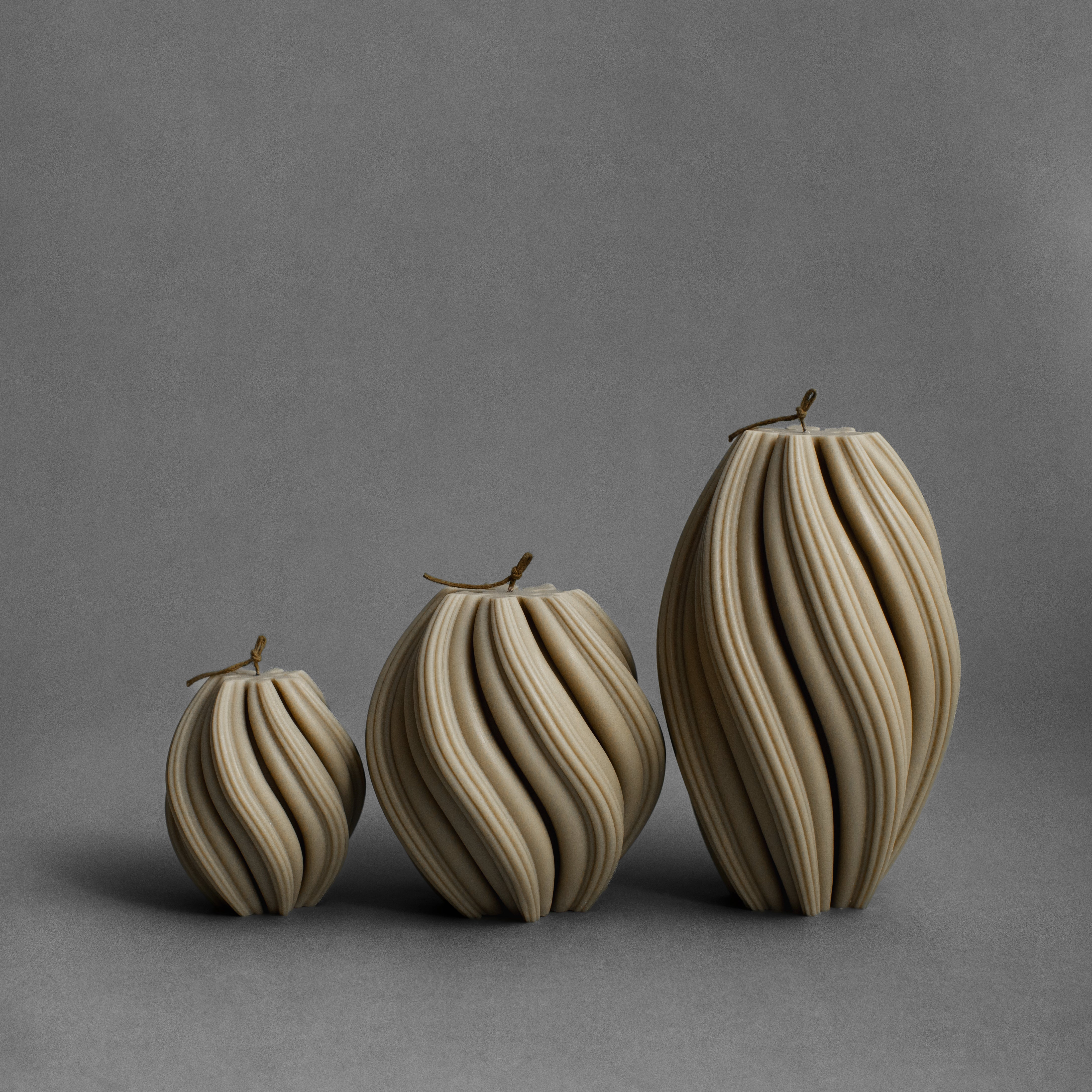 Set of three olive beige swirl pillar candles by LAWA in small, medium, and large