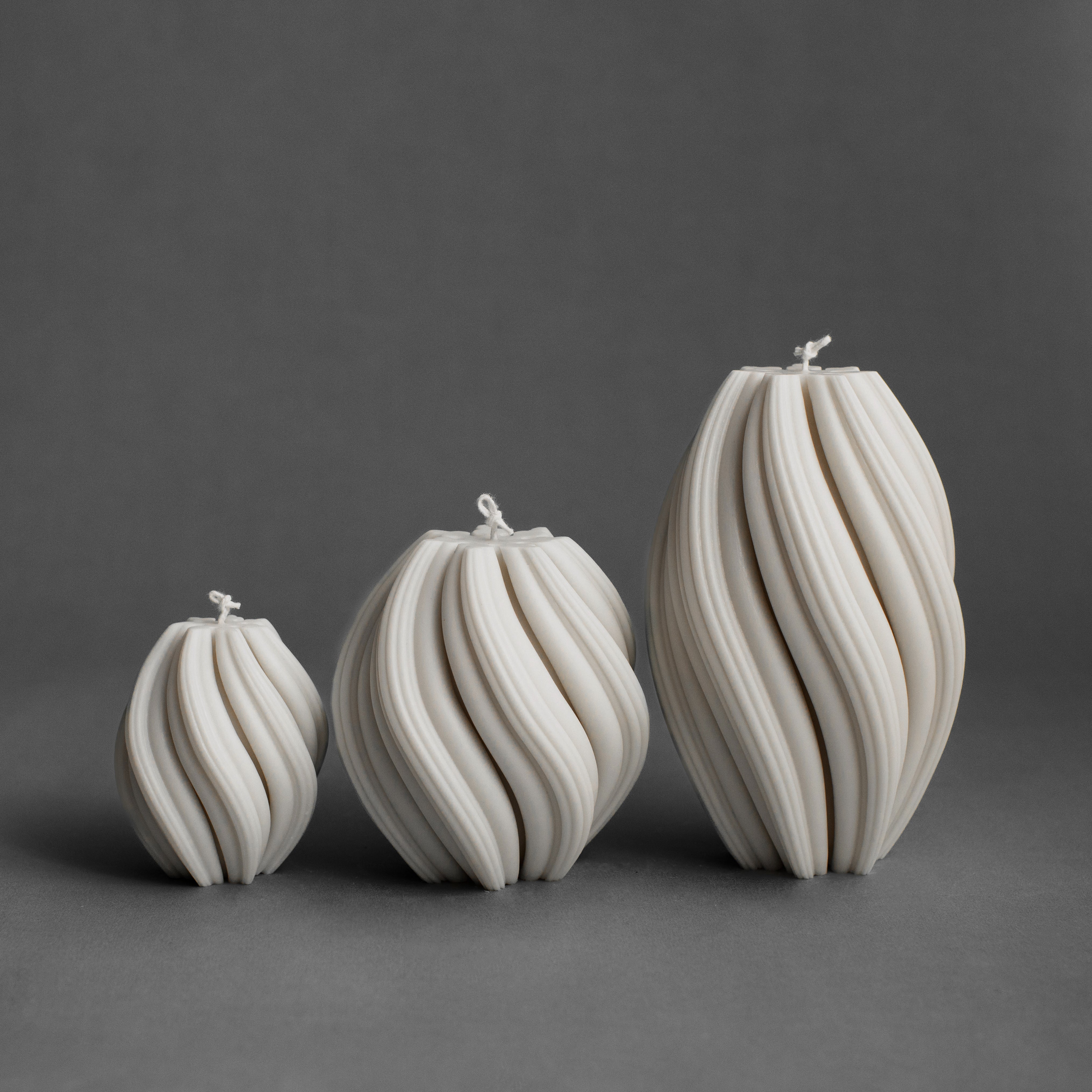 Set of three white swirl pillar candles by LAWA in small, medium, and large