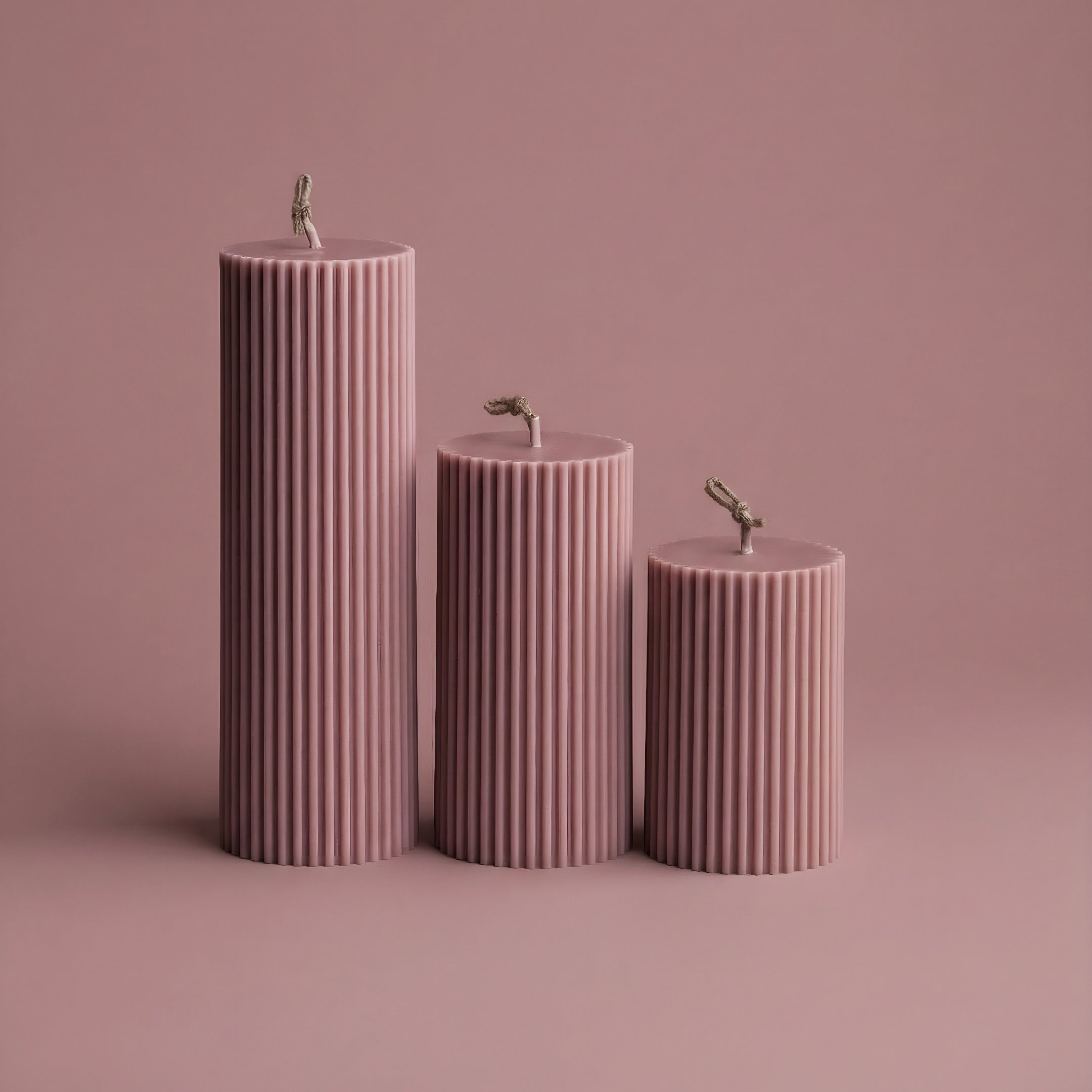 Close-up detail of handmade ribbed sculptural candle showing textured soy wax surface and natural cotton wick