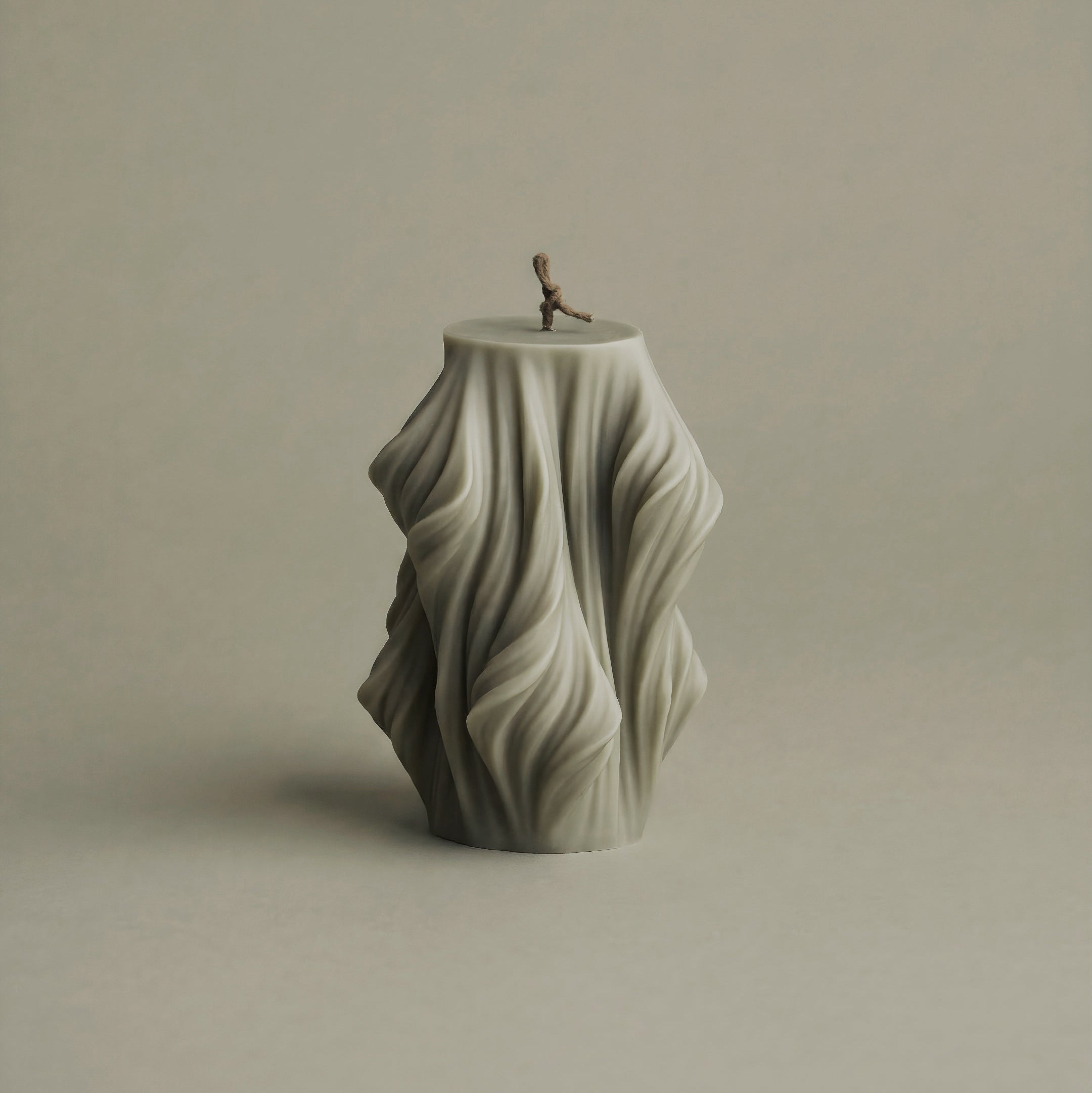 Close-up detail of handmade Cascading Wave sculptural candle showing smooth soy wax texture and flowing design
