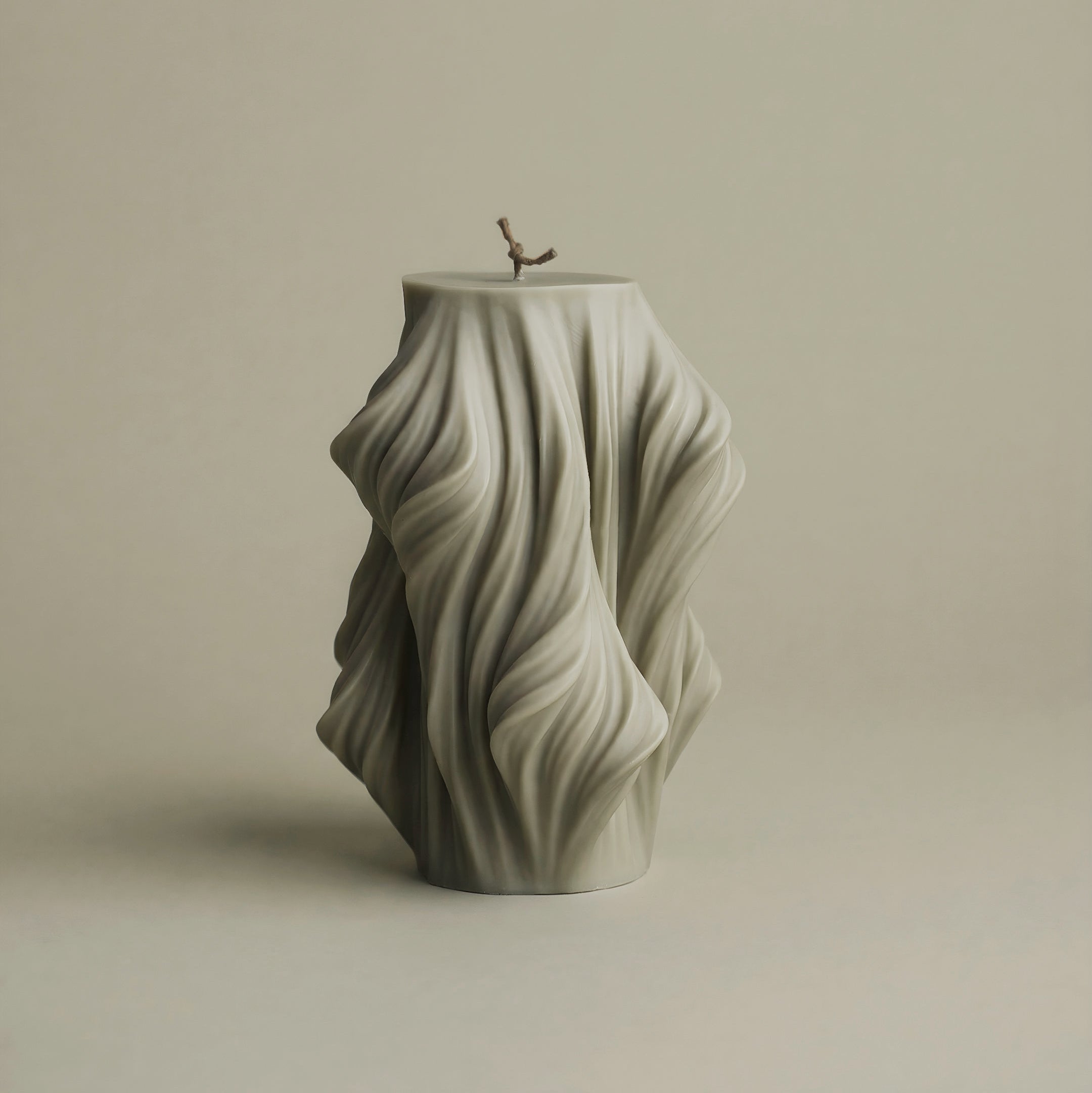 Close-up detail of handmade Cascading Wave sculptural candle showing textured soy wax layers and flowing design