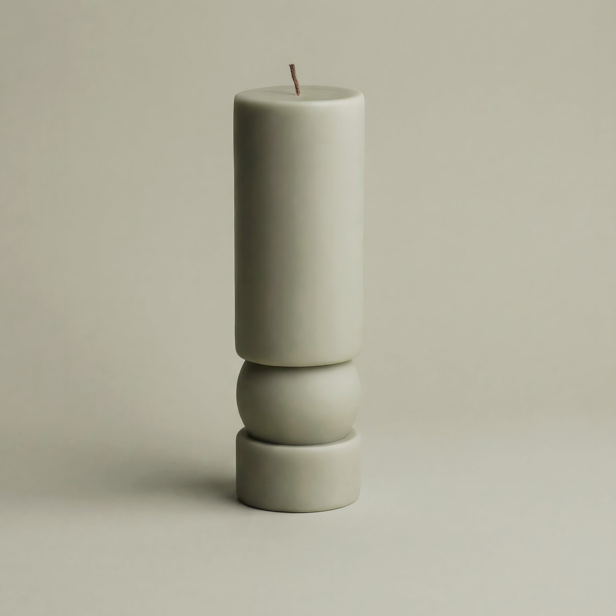Handmade sculptural candle detail showing smooth soy wax texture and natural cotton wick in minimalist Zen design