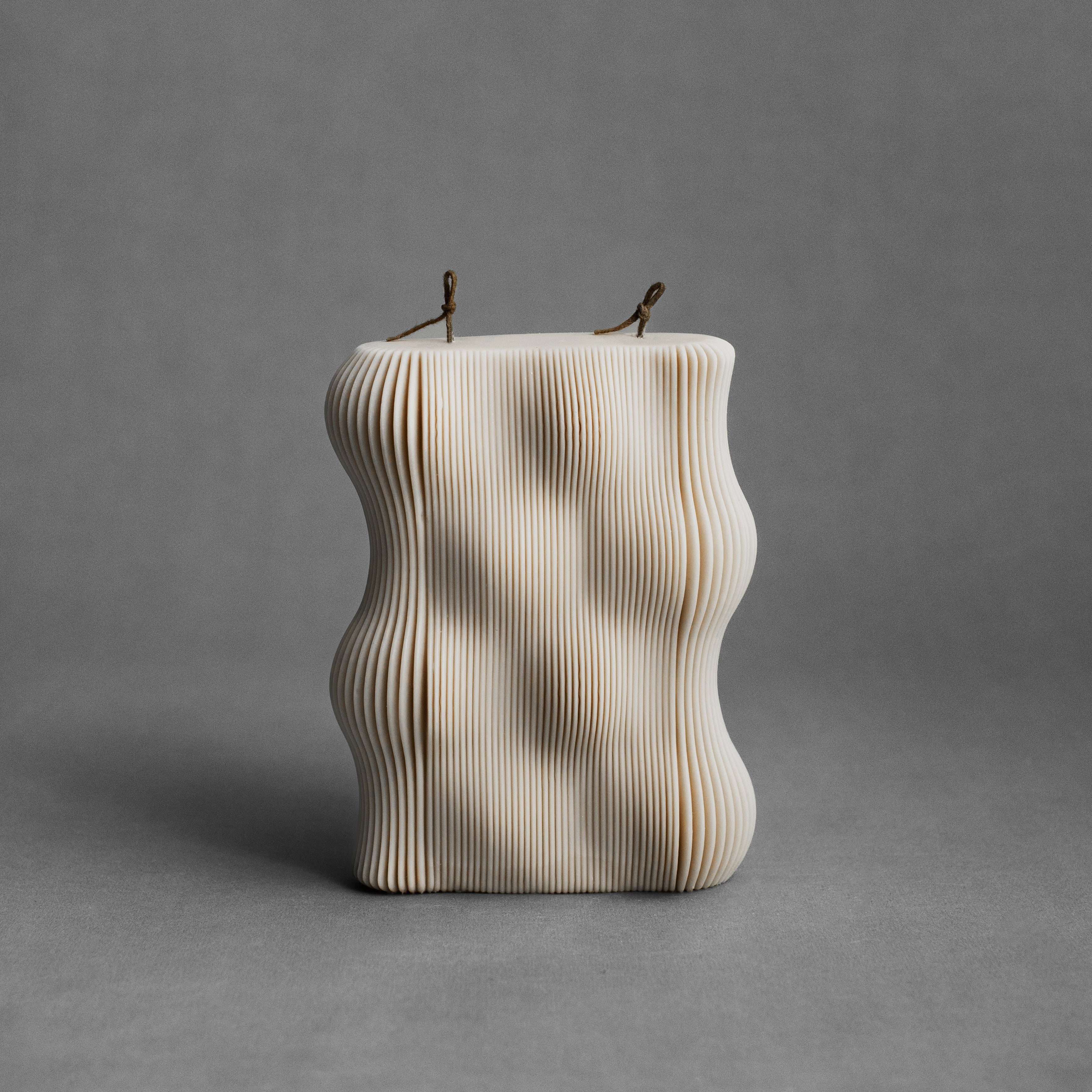 Moon gray wavy pillar candle by LAWA with sculptural wave texture